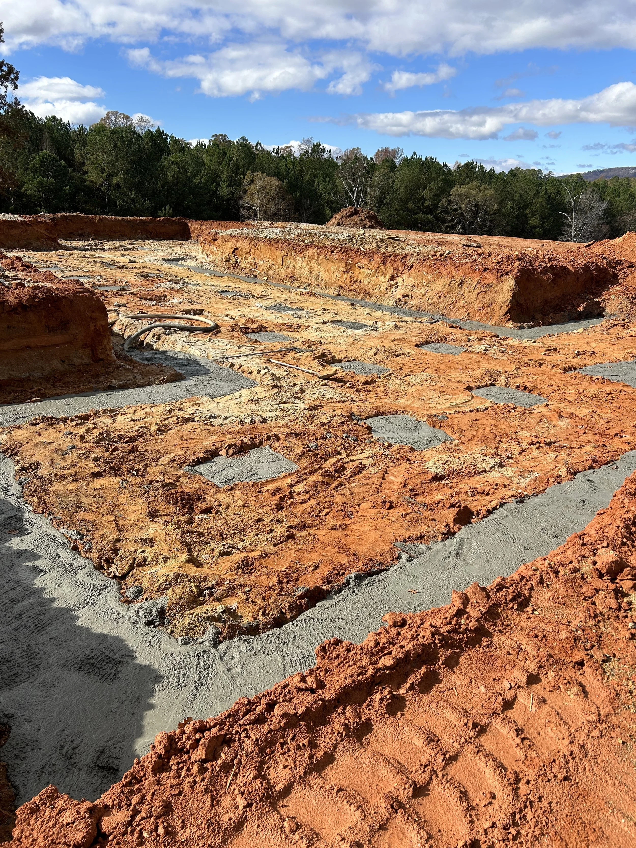 Dug out for a sunken crawlspace. Poured concrete footers.