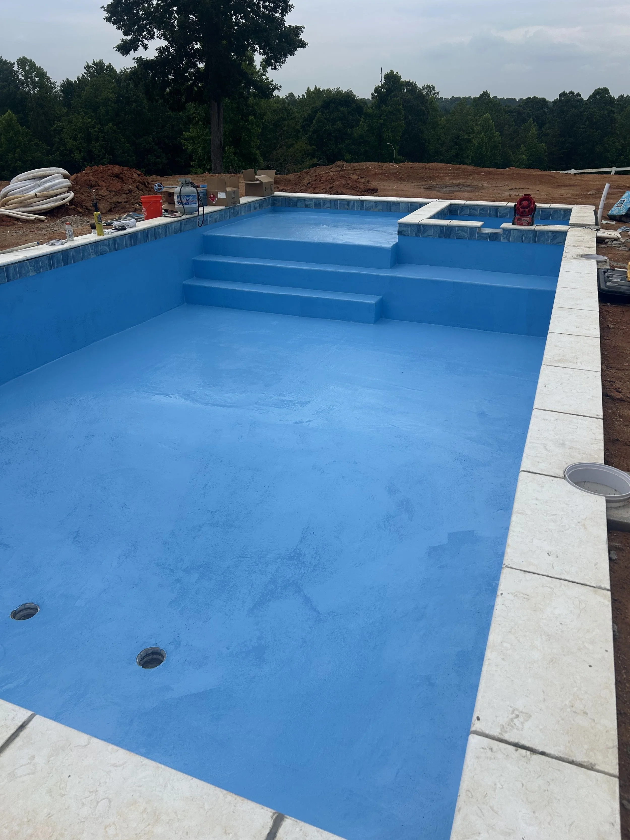In ground concrete pool with epoxy coating. Limestone coping. Built in hot tub and sundeck.