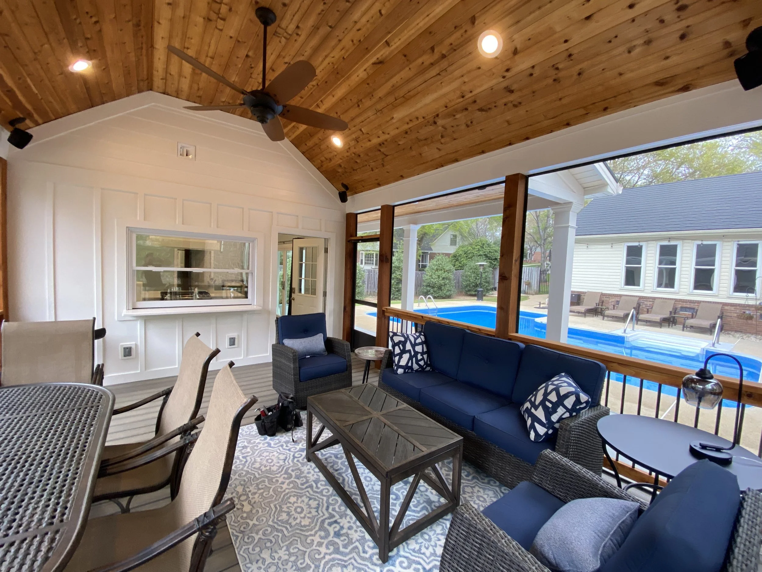 Detached pool house private screened in porch. Screen-Eze screen system installed on outside of cedar handrails with aluminum balusters. Aluminum screened door. Vaulted cedar tongue and groove ceiling. Fold up pass through window.