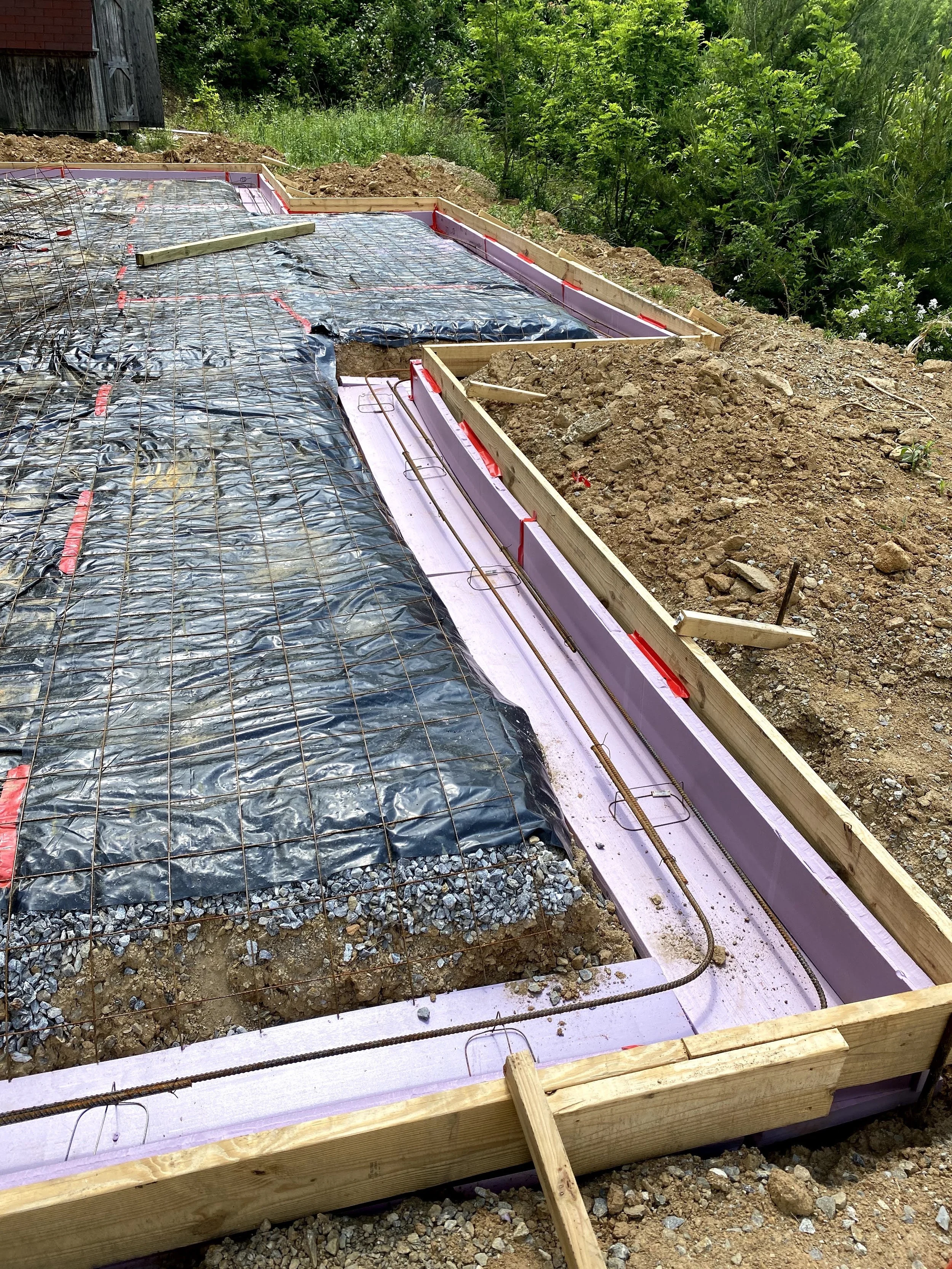 2" ridgid board insulation installed on bottom and side of footer with two rows of half inch rebar along all footers.