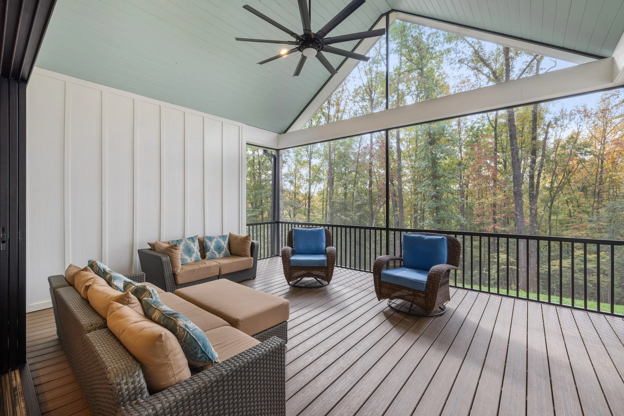 Screened in porch. Fiber cement board and baton siding. Painted 1x6 pine tongue and groove ceiling. Black aluminum extruded aluminum screen wall with balusters. Trex Select decking installed with Trex hidden fasteners.