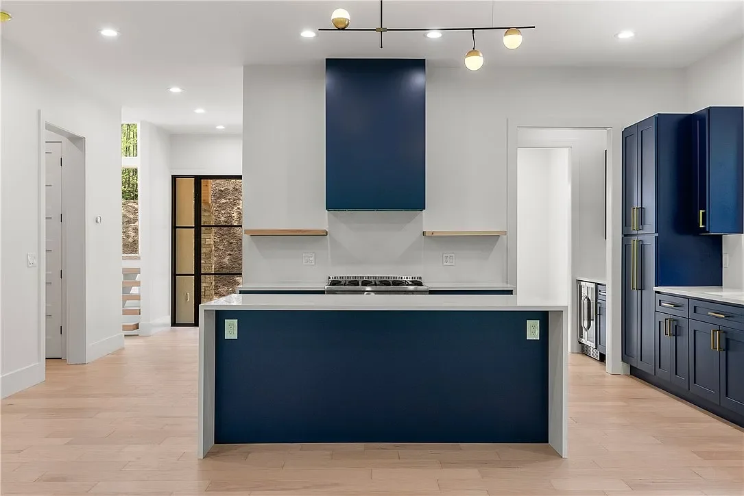 Wide plank LVP flooring. Semi-custom cabinets with Quartz counters with waterfall edges on island. 
