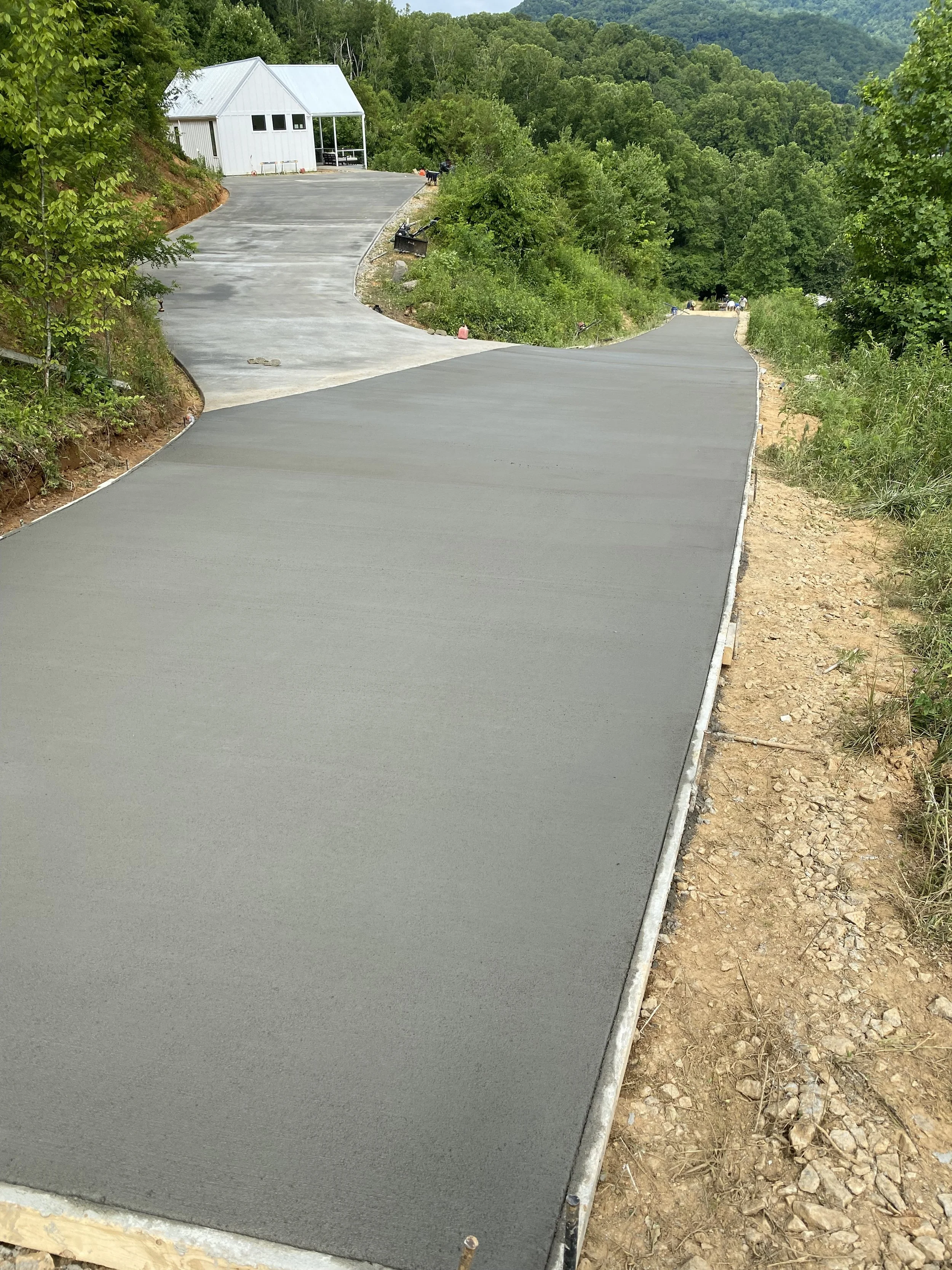 Concrete driveway formed and poured. Broom finish.