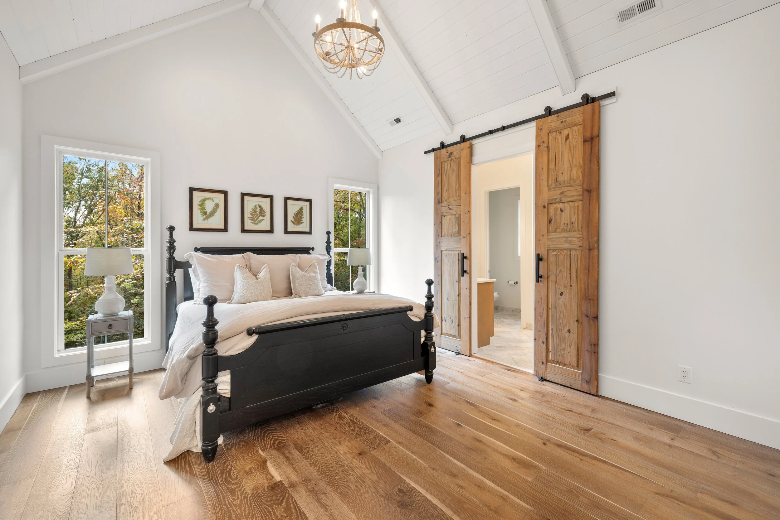 Wide plank engineered hardwood floors. Vaulted painted tongue and groove wood ceiling with decorative beams. Custom double barn doors.