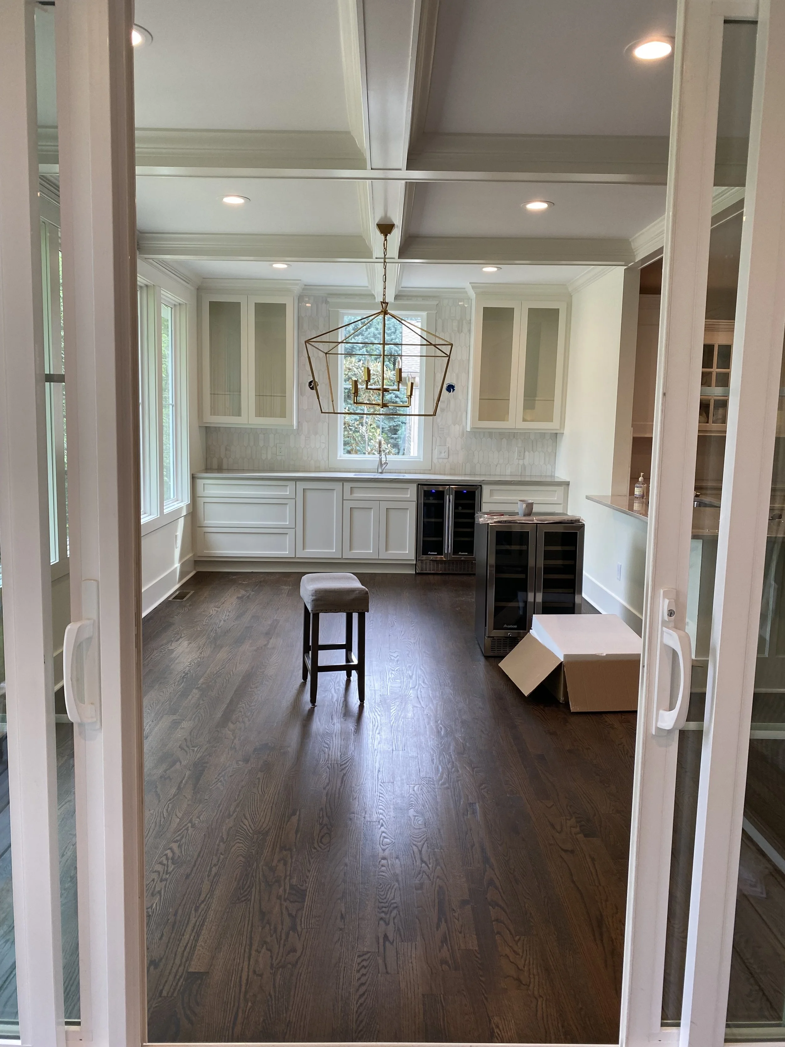 Dining room/sun room addition off of porch addition. Custom bar cabinetry. Coffered ceiling. Hardwood floors to flow seamlessly into the existing interior of the home.