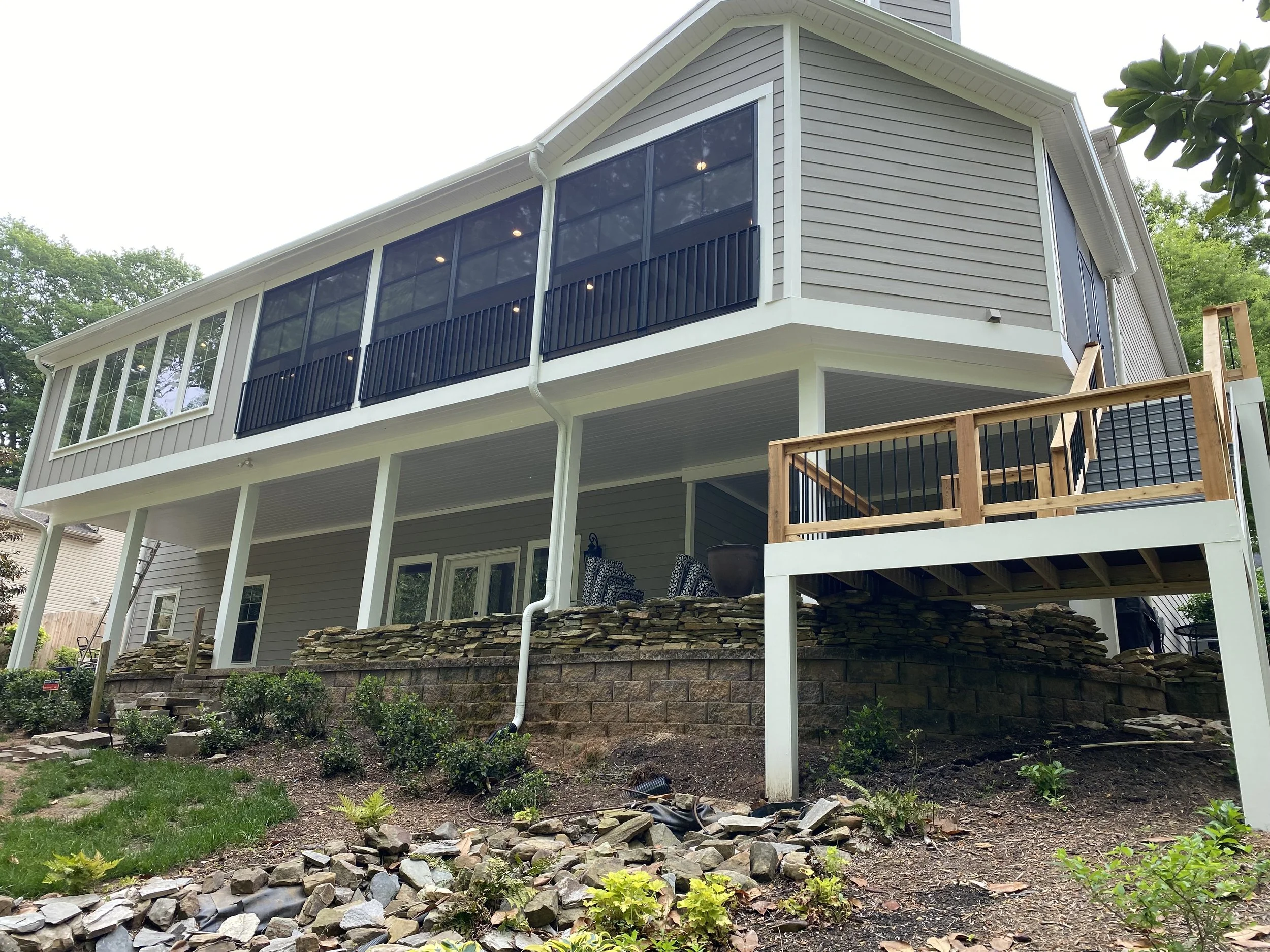 Large three season porch addition with dining room/sun room addition. Eze Breeze window system with aluminum safety rail outside window units. Fiber cement plank siding. 
