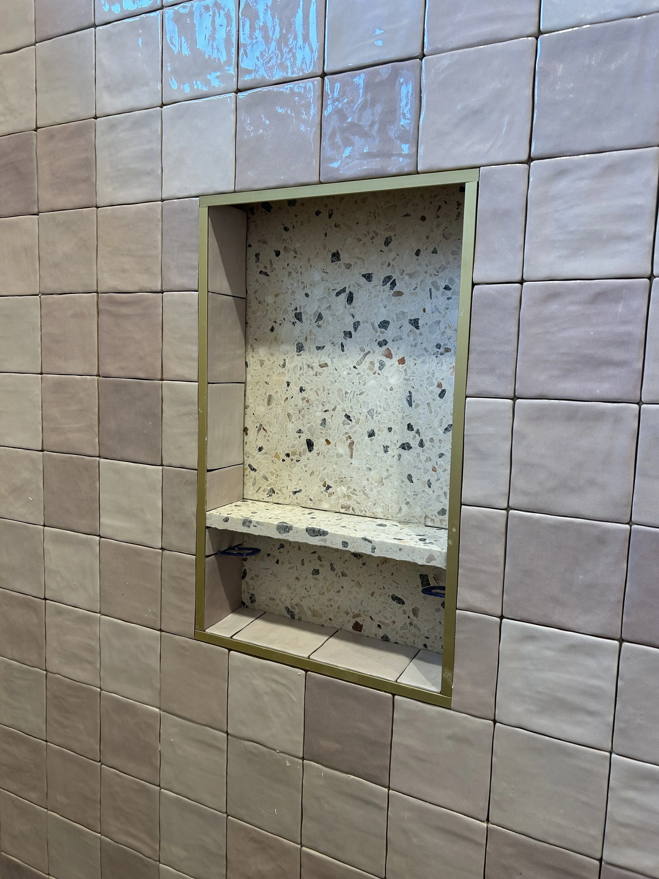 Custom niche with Terrazzo shelf and back.