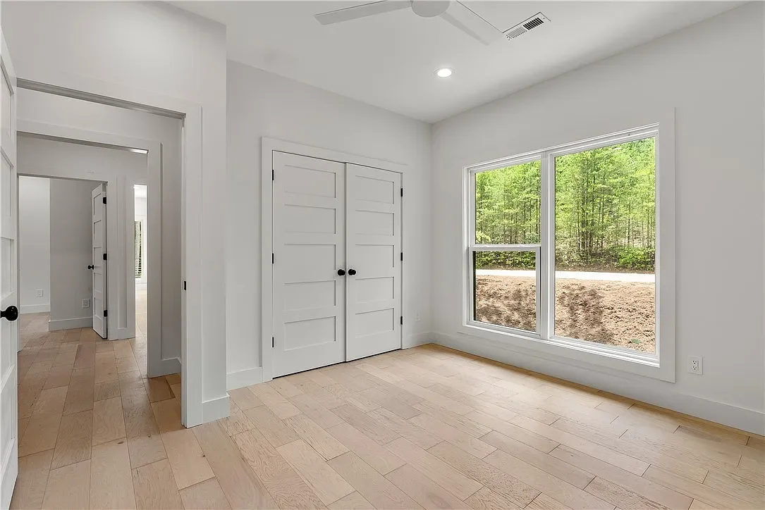 Wide plank LVP flooring. Single hung with fixed window. 8' solid core wood doors.