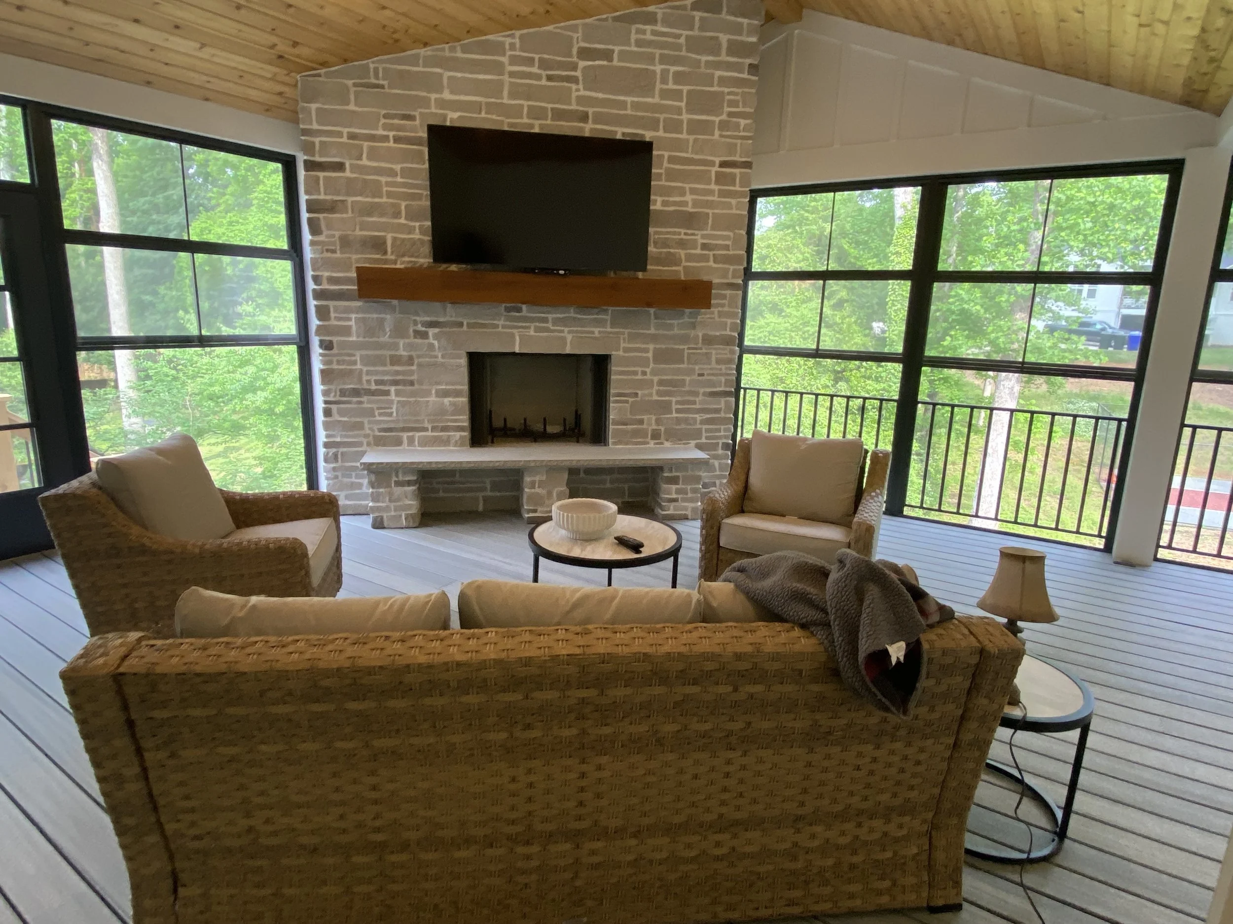 Large three season porch addition. Eze Breeze window system with aluminum safety rail outside window units. TimberTec composite decking. Cedar tongue and groove ceiling. Fiber cement board and baton siding. Stone fireplace.