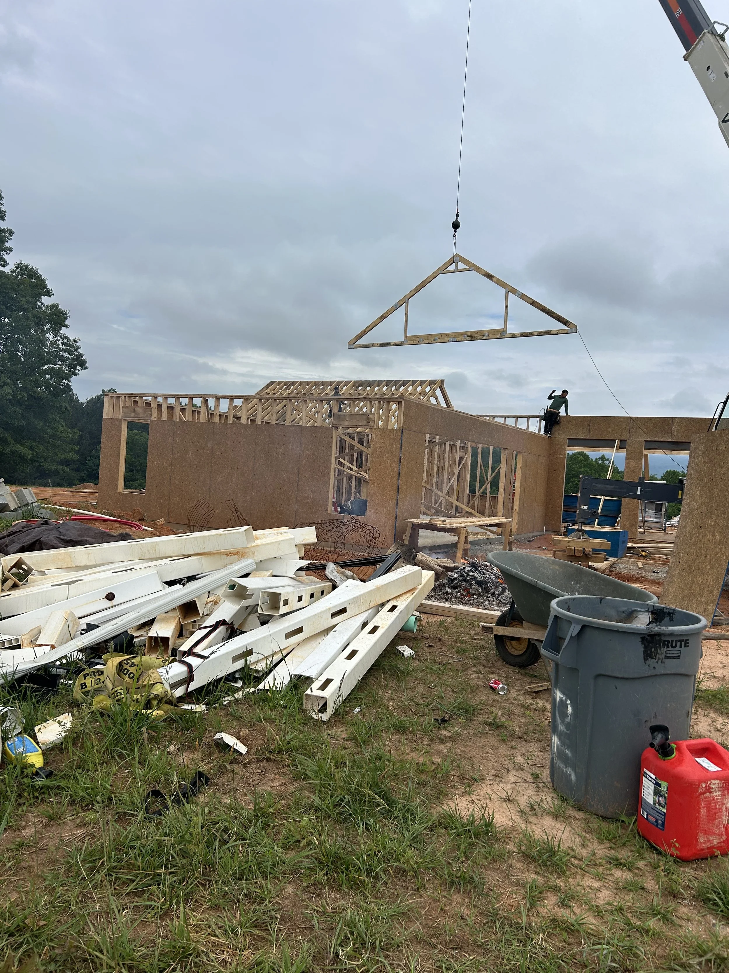 Trusses with built in attic area installed above garage. Rest of roofs are all stick built.