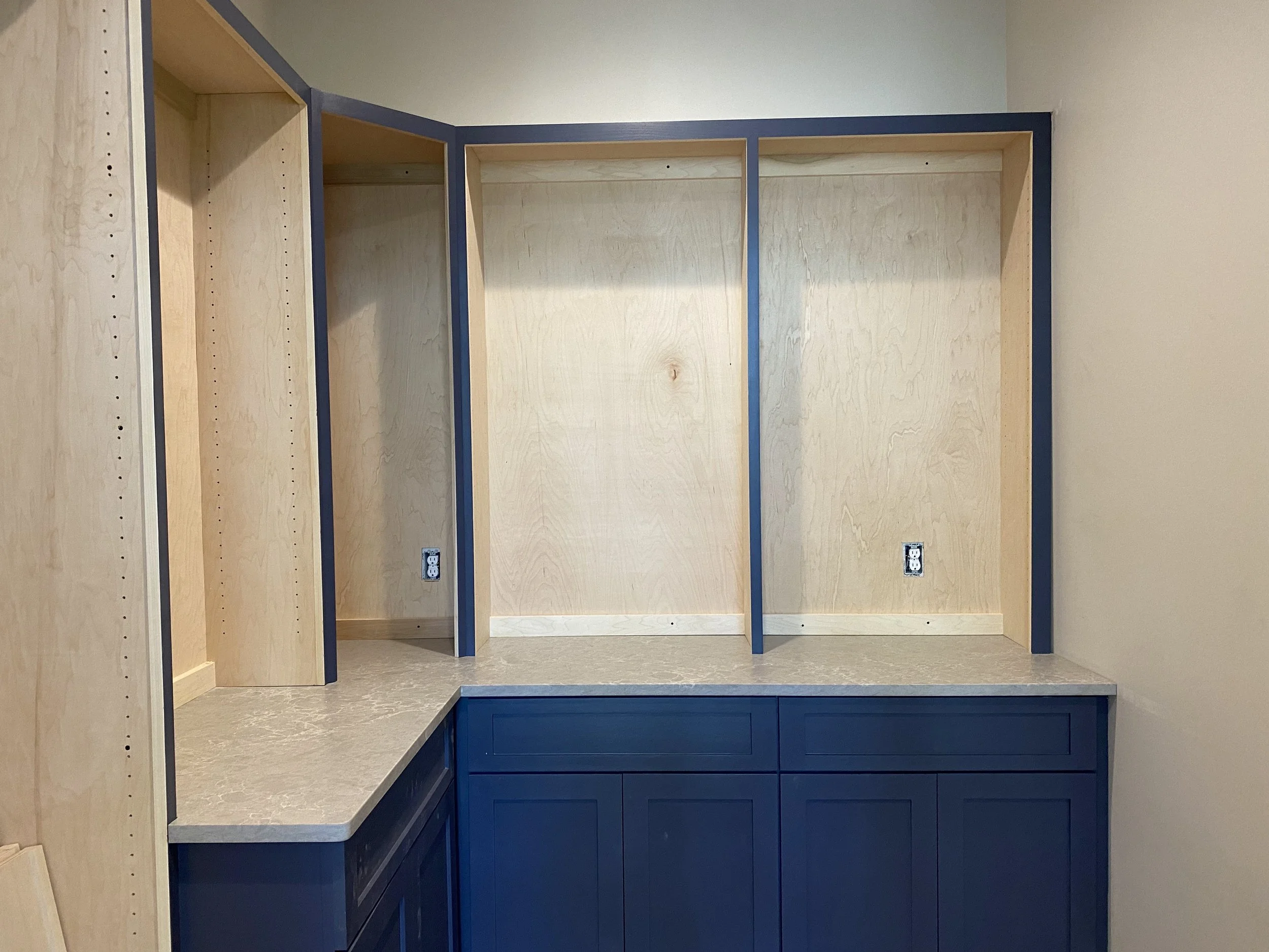 Custom cabinetry in large walk in pantry with Quartz counter tops.