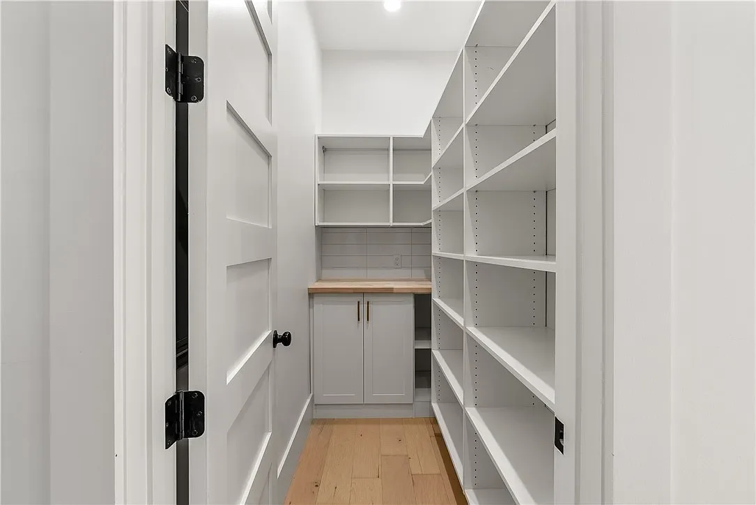 Custom pantry with butcher block top. 8' tall solid core wood doors.