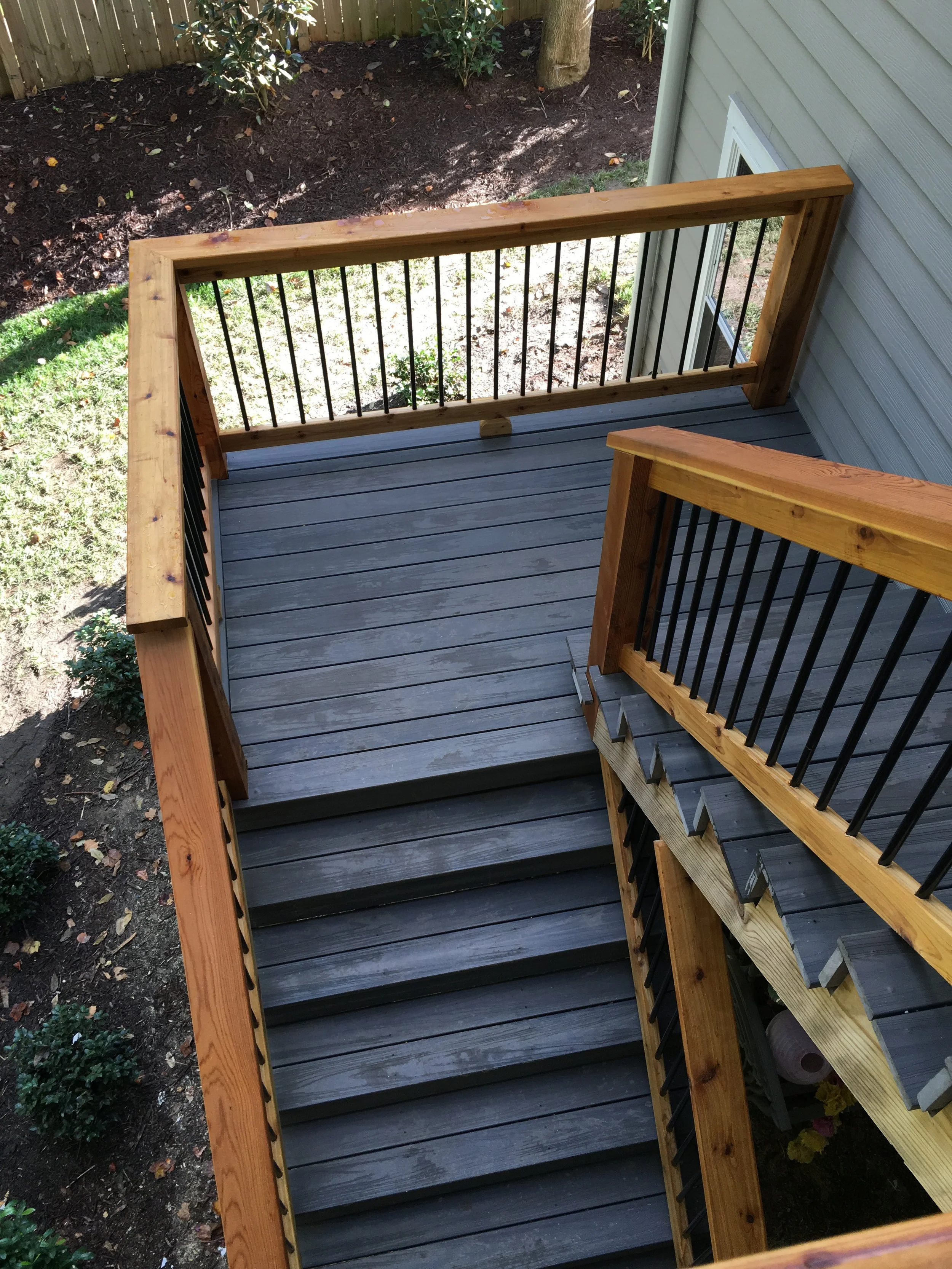 Landings and stairs down to bottom patio. TimberTec composite decking and cedar handrails with aluminum balusters.