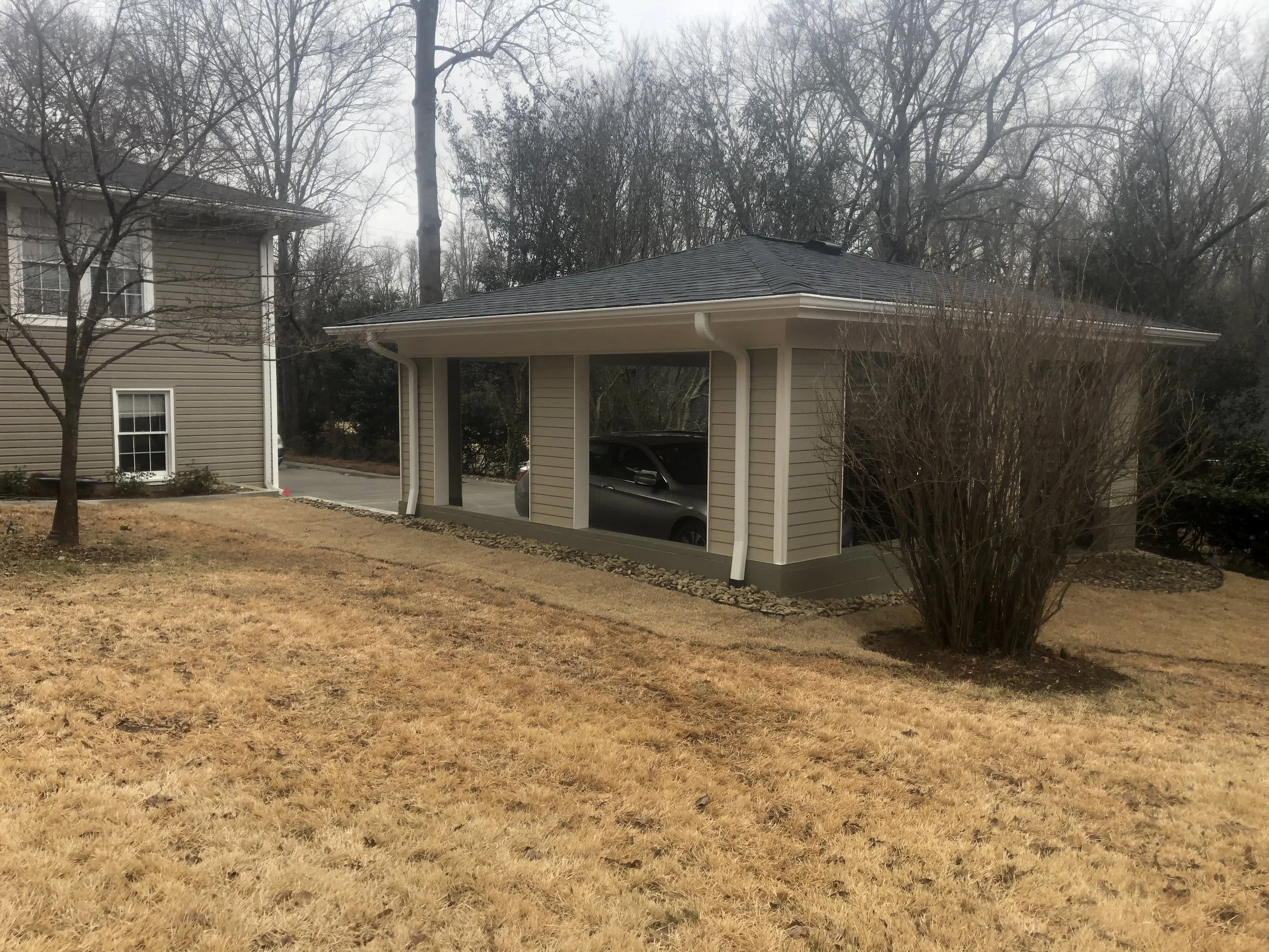 Detached carport with fiber cement siding, and asphalt architectural shingles.
