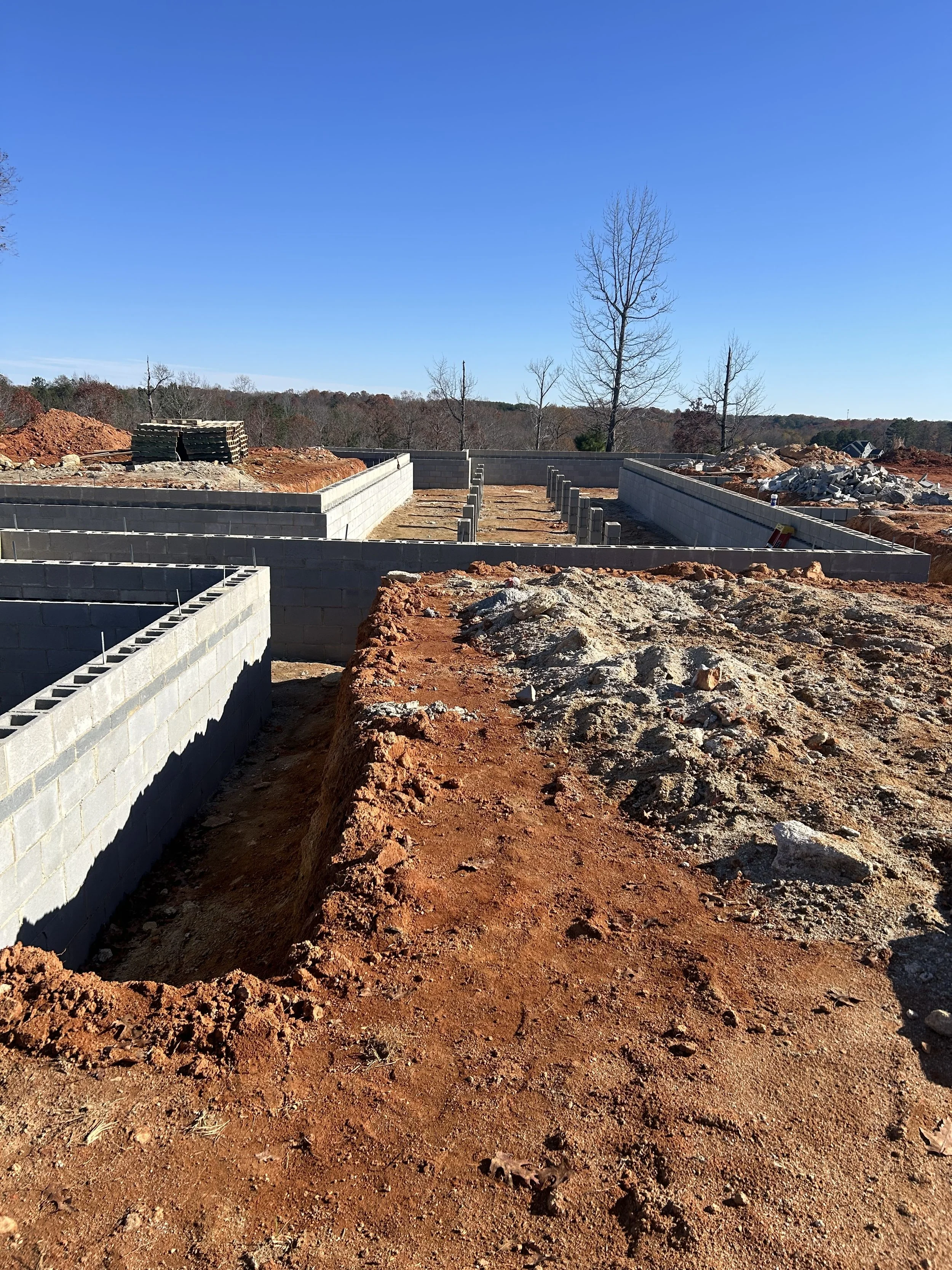 Block complete. 12" block to support floor framing weight. 8" block set flush with exterior of foundation to cover floor framing later, which allows us to have the outside grade higher up on the home, allowing for less or no steps upon entering the h