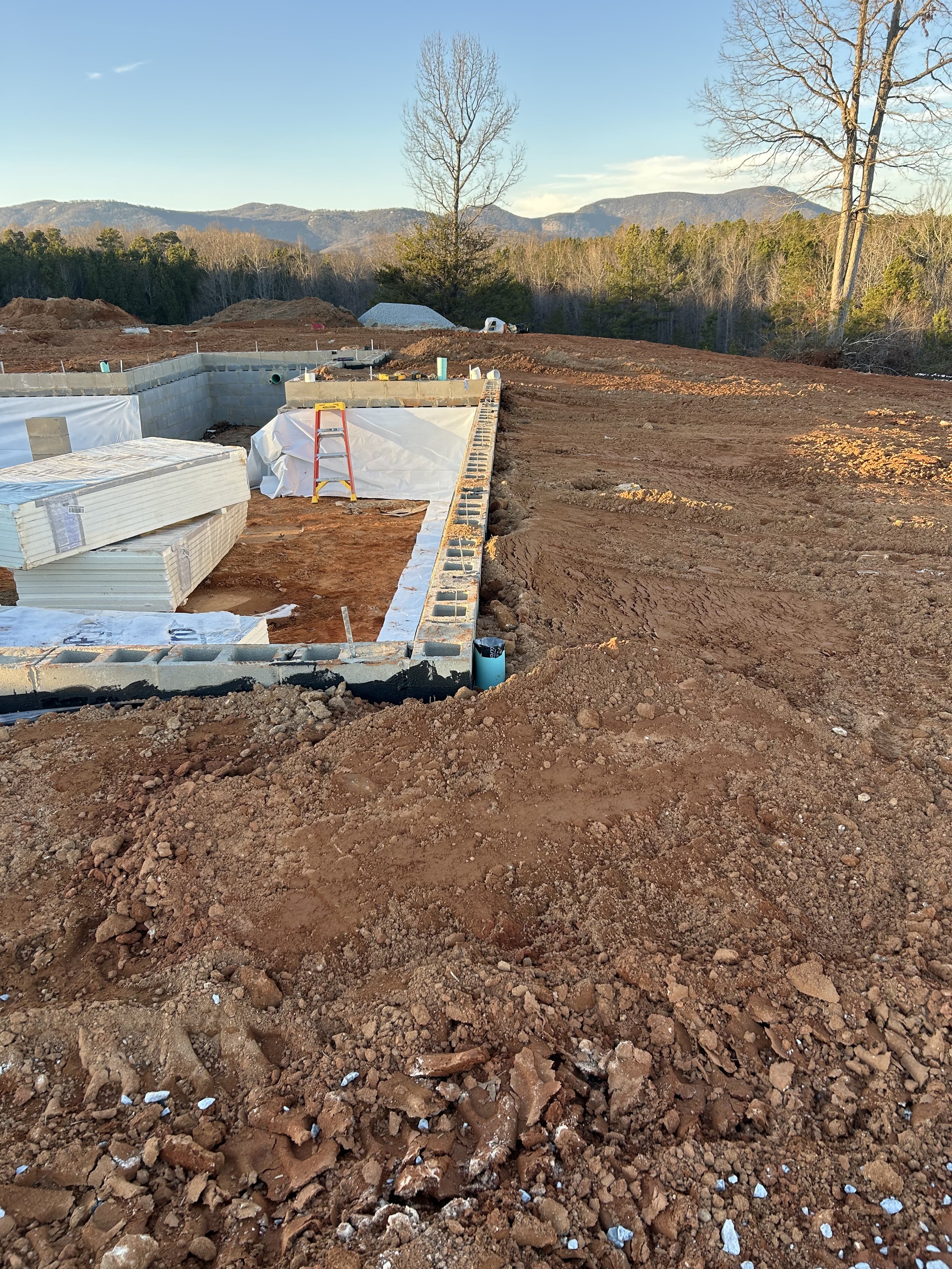 20mil poly installed on walls for beginning of crawlspace encapsulation. Foundation backfilled against.
