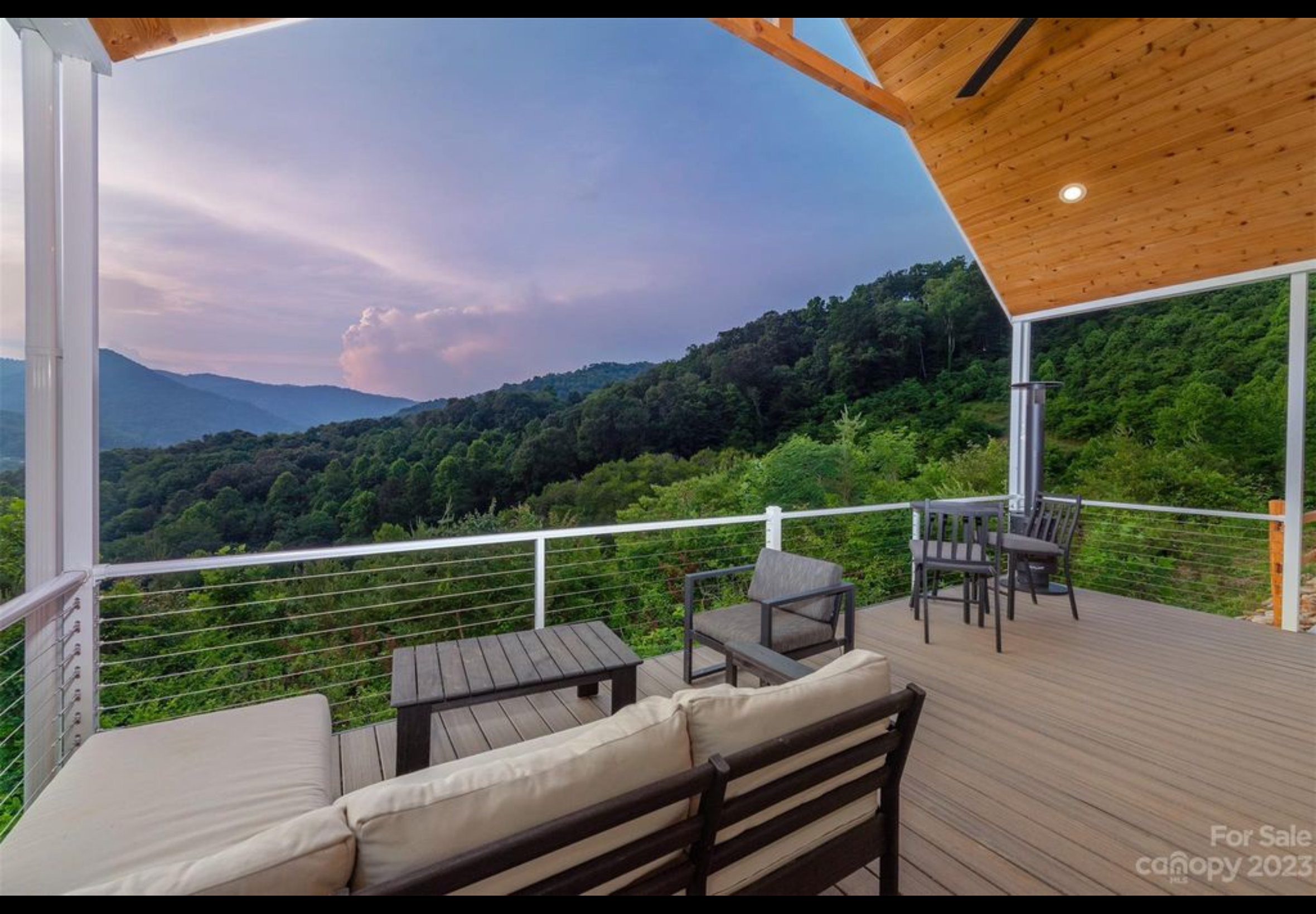 Finished front porch deck. Extruded aluminum handrail with cable railing. Trex Enhanced Naturals decking installed with Trex hidden fasteners.