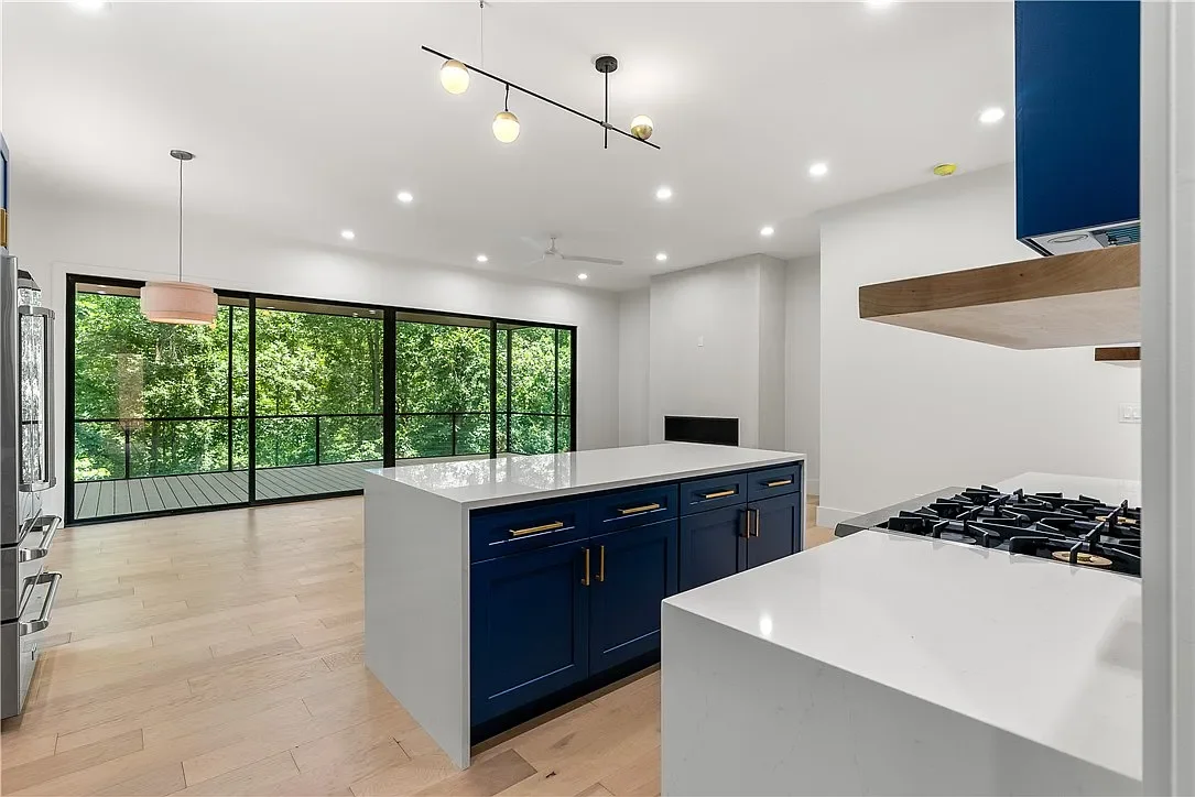 Wide plank LVP flooring. Semi-custom cabinets with Quartz counters with waterfall edges on island. Modern ventless gas fireplace.