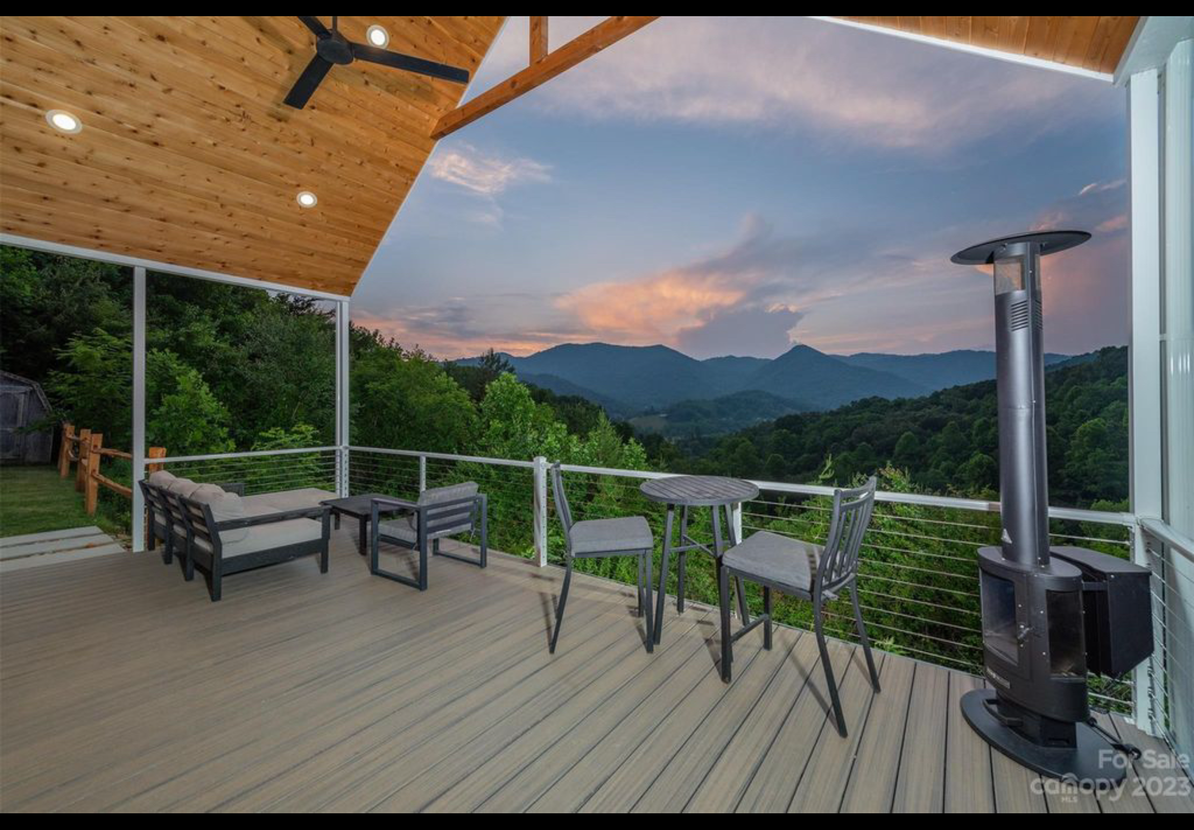 Finished front porch deck. Extruded aluminum handrail with cable railing. Trex Enhanced Naturals decking installed with Trex hidden fasteners. Cedar tongue and groove ceiling. Cedar split rail fence.