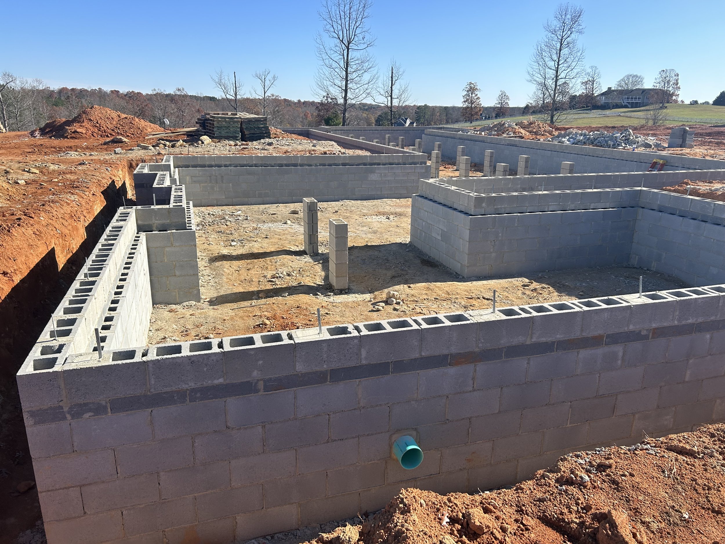 Block complete. 12" block to support floor framing weight. 8" block set flush with exterior of foundation to cover floor framing later, which allows us to have the outside grade higher up on the home, allowing for less or no steps upon entering the h