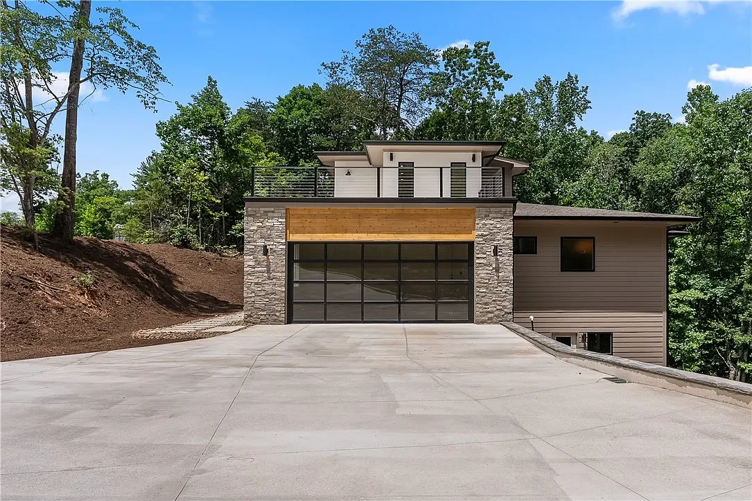 18x8 aluminum and glass garage door. Cedar, stone, and stucco siding.