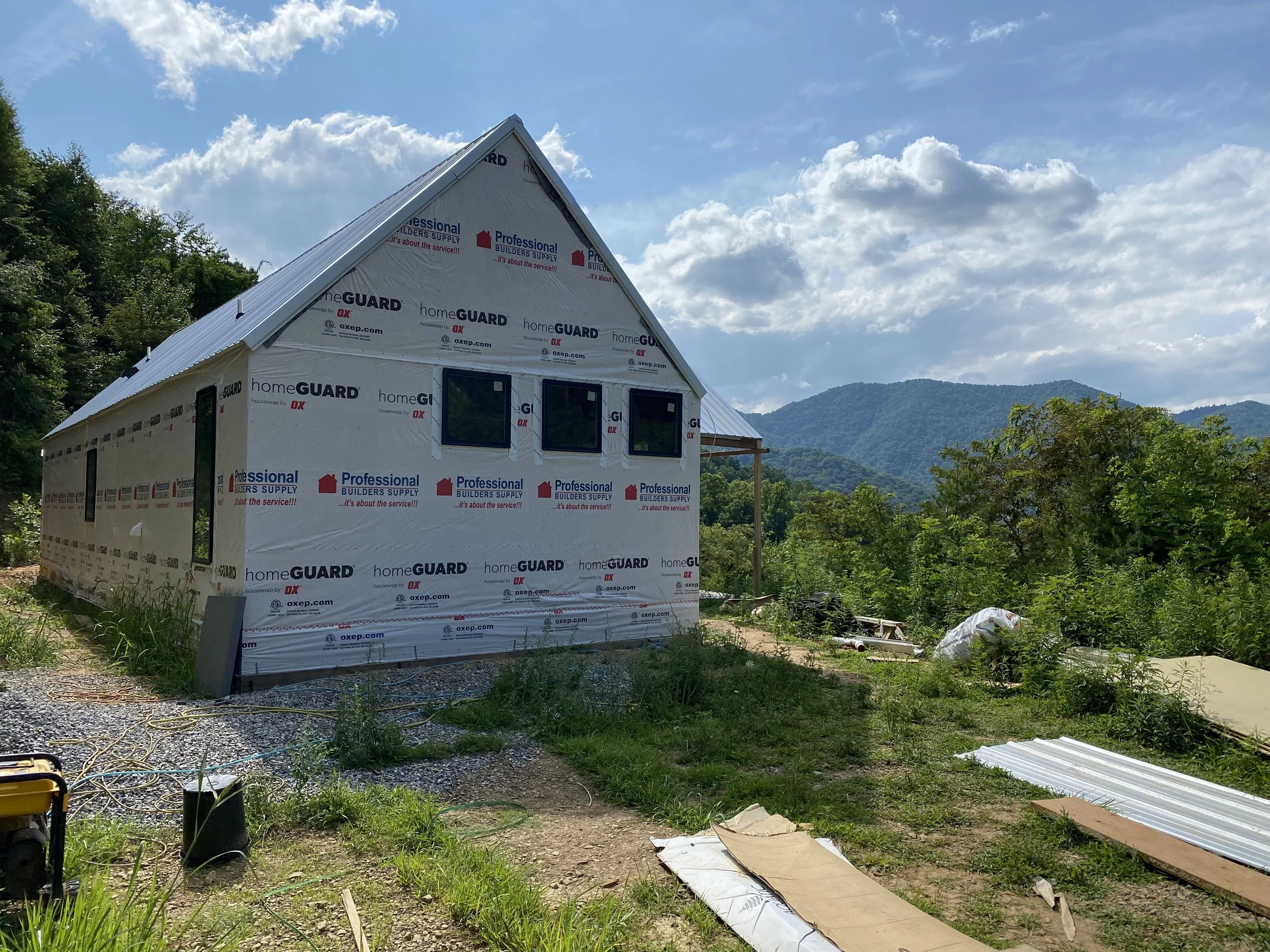 House wrap and vinyl windows installed. Galvanized Tough Rib metal roofing installed.