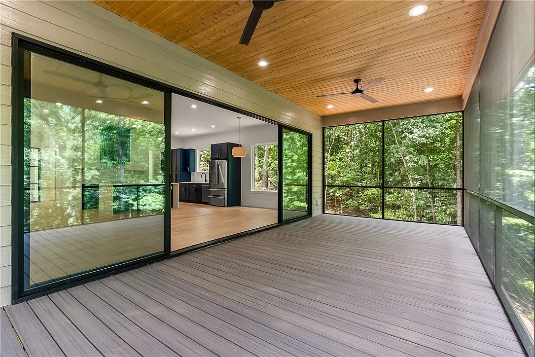 20'x8' 4 panel Western bi parting sliding door. 1x6 cedar tongue and groove porch ceiling. Rocky Slope Trex Enhance Naturals composite decking installed with Trex hidden fasteners. Extruded aluminum screen wall with cable rail.