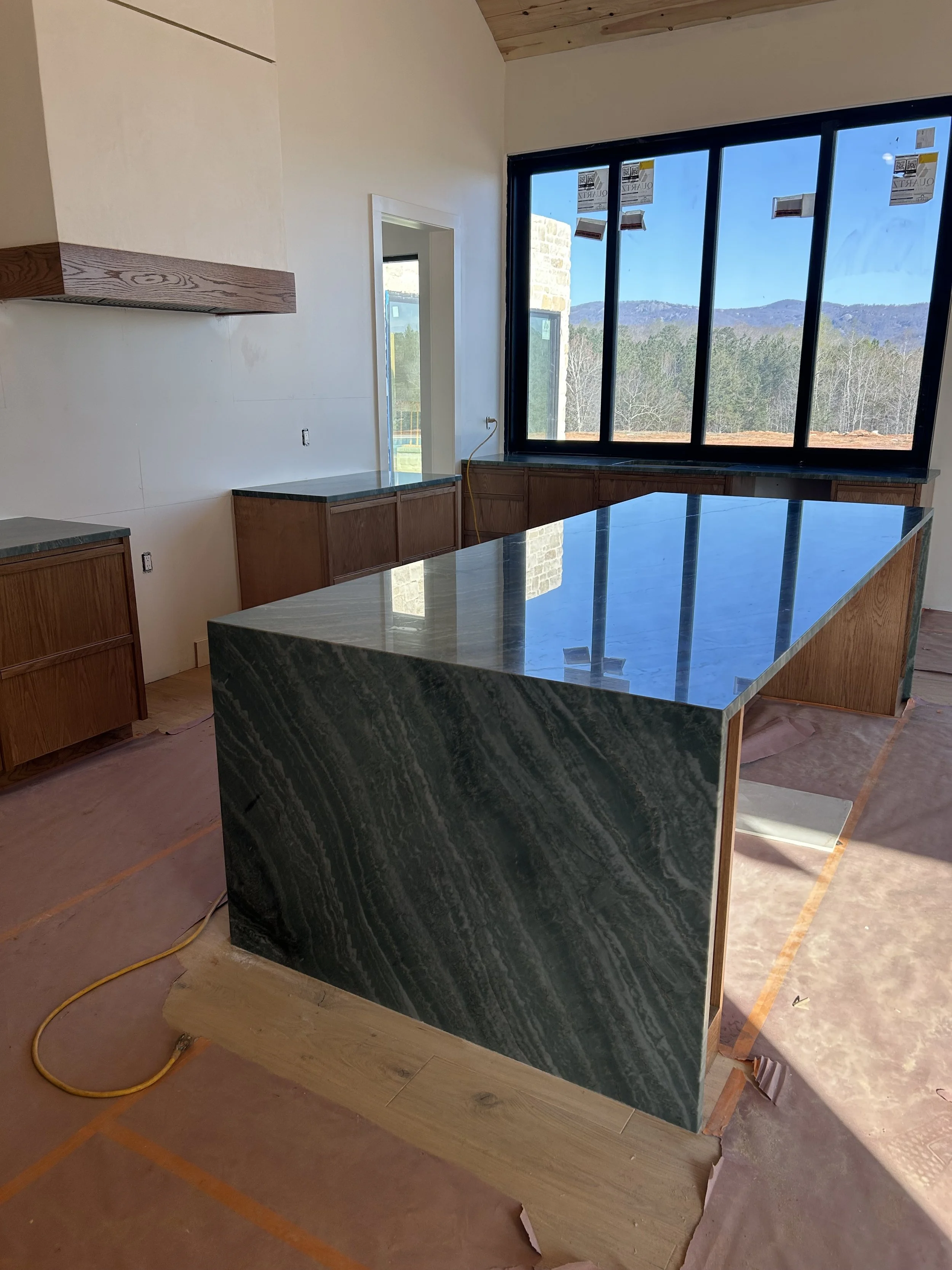 Quartzite countertops with waterfall edges on island.