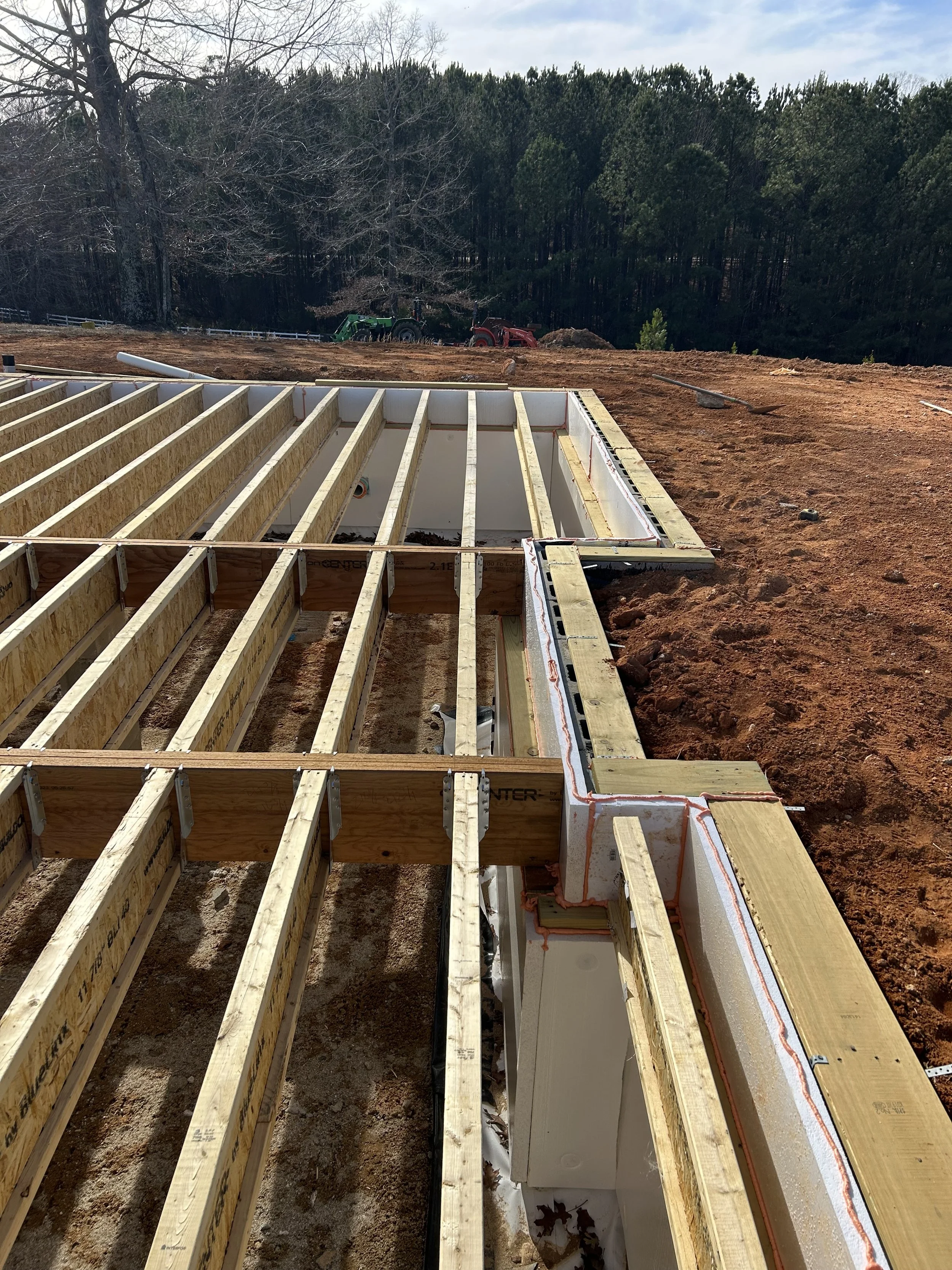 2" ridgid insulation foam board installed on all foundation walls from crawlspace floor to level with top of floor joists. Spray foam insulation placed in any possible voids. LVL flush support beams. 12" TJI floor joists hung from support beams. Beam