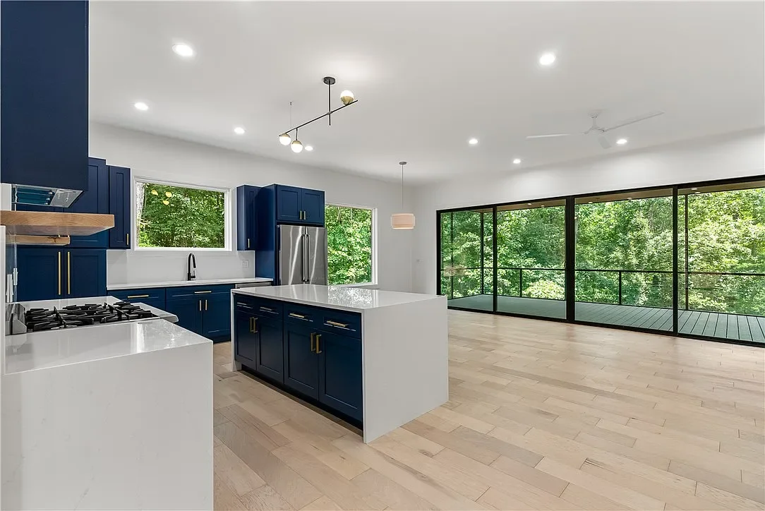 Wide plank LVP flooring. Semi-custom cabinets with Quartz counters with waterfall edges.