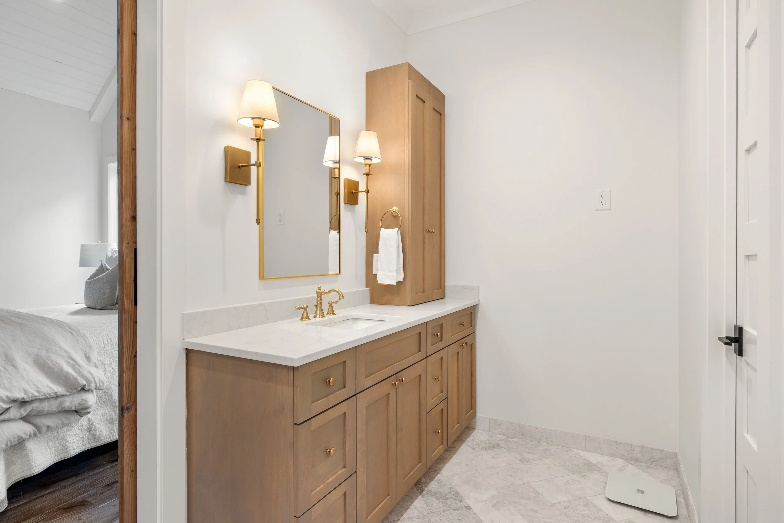 Custom built vanities with quartz counters.