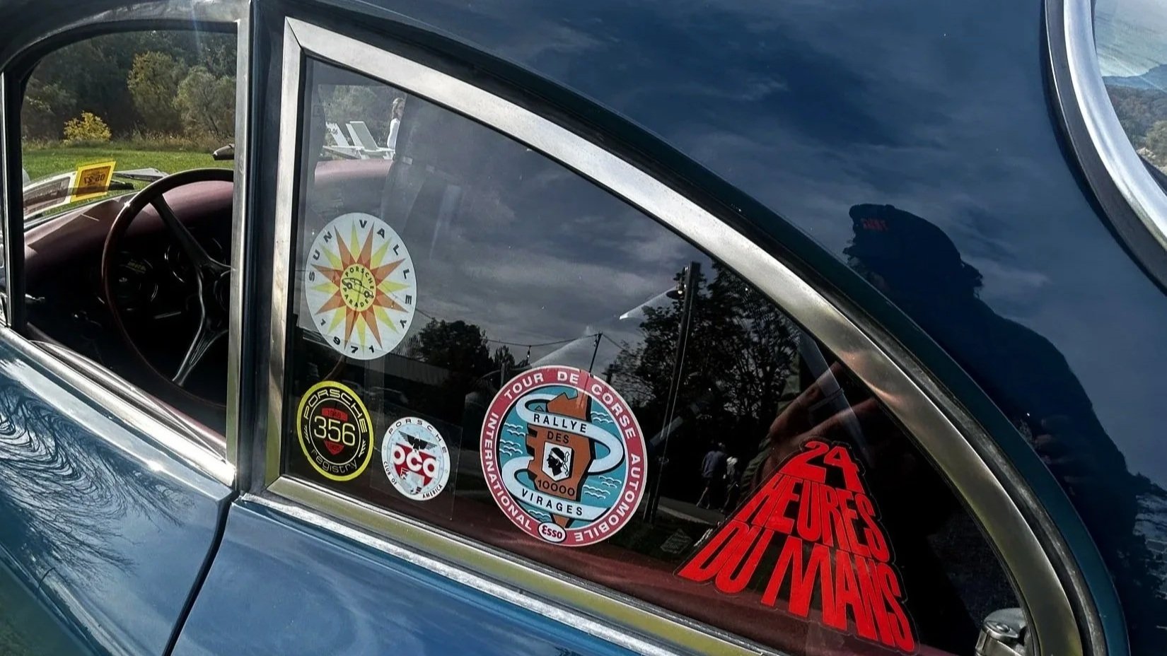 Stickers and personal graphics displayed on a car window at INNESS.