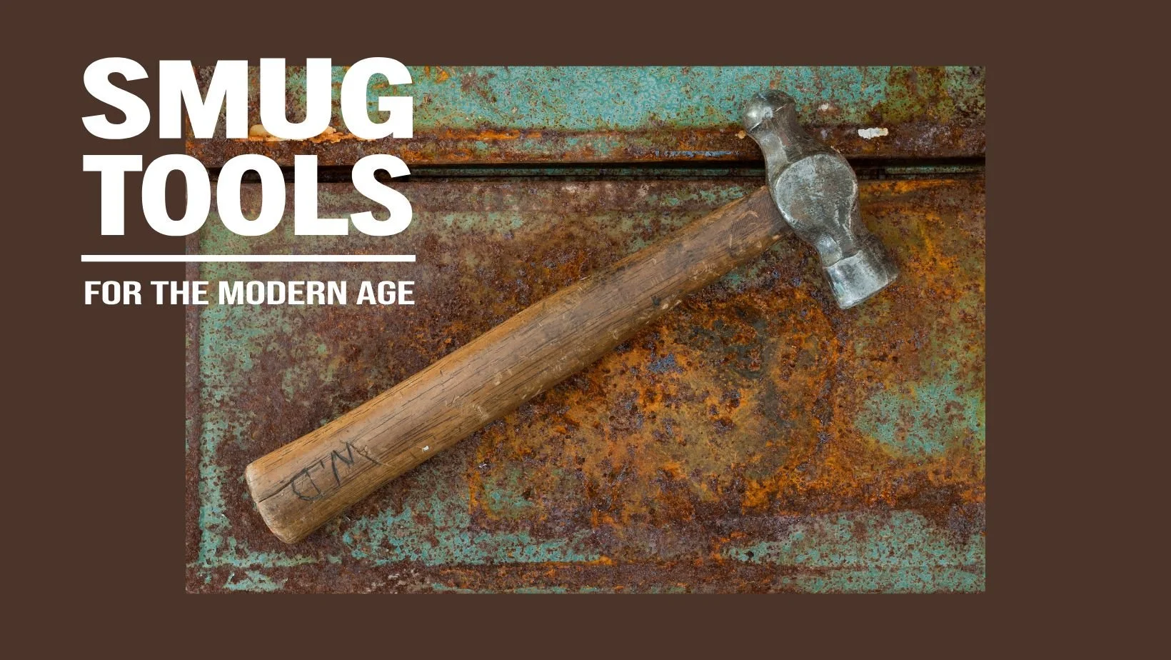 SMUG TOOLS "For the Modern Age" banner showing a worn ball peen hammer with initials scratched into the handle, lying on a rusted teal metal surface