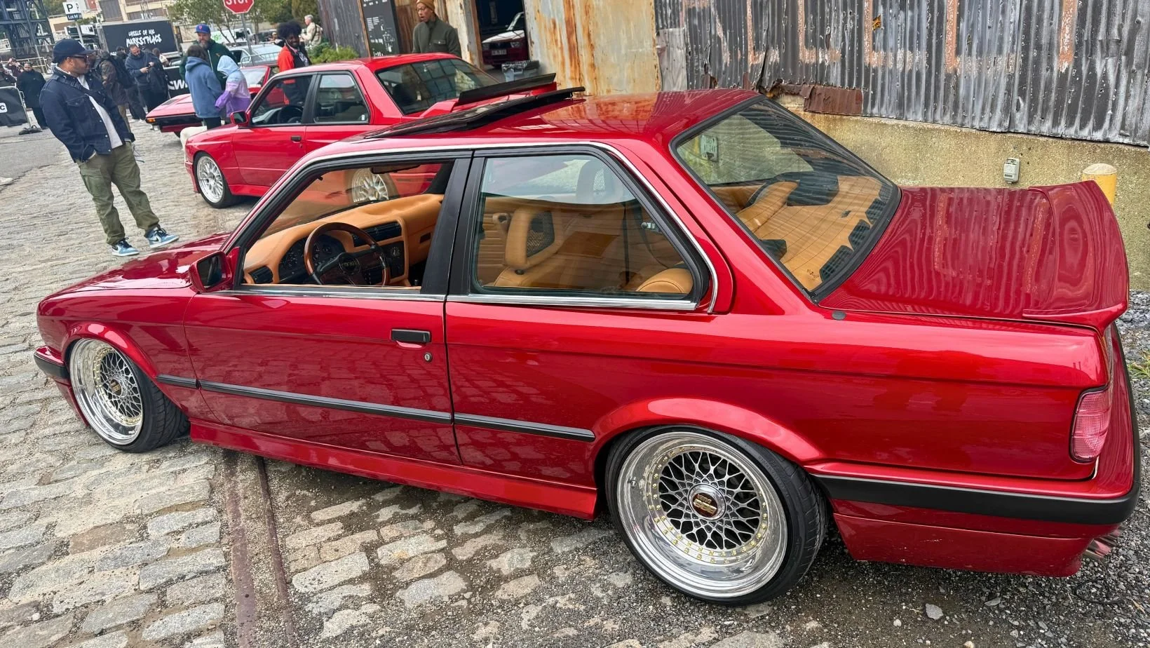 Red BMW E30 photographed at the October 17 Wheels show.