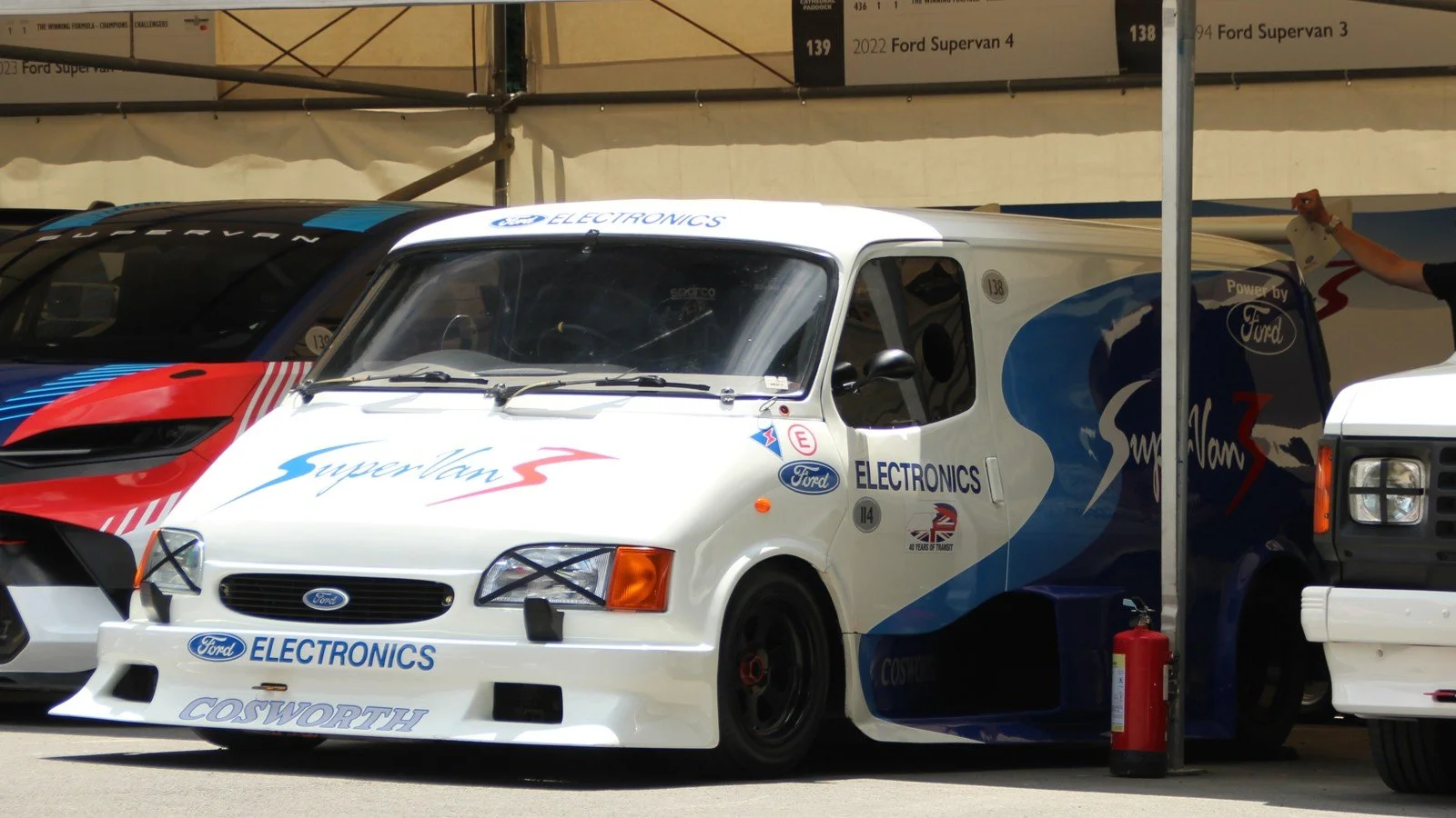 Ford Supervan 3 displayed outdoors with racing bodywork and sponsor graphics.