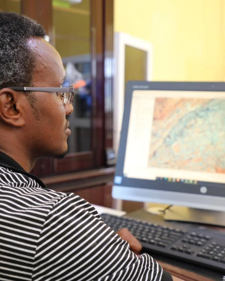 An analyst reading a satellite composite on screen