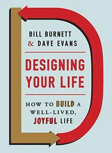 Cover of a book titled 'Designing Your Life' by Bill Burnett and Dave Evans, with a title subtitle 'How to Build a Well-Lived, Joyful Life.' The cover has a stylized arrow design.