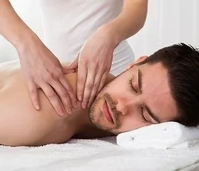 Man lying face down receiving a massage on his back