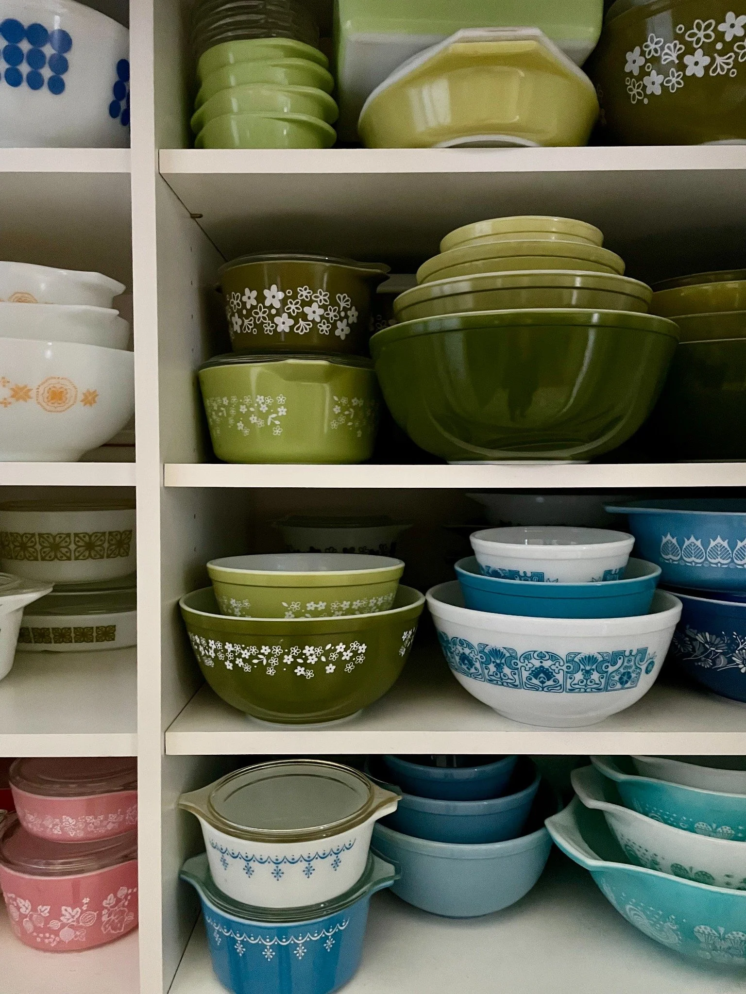 Shelves filled with a colorful vintage Pyrex collection