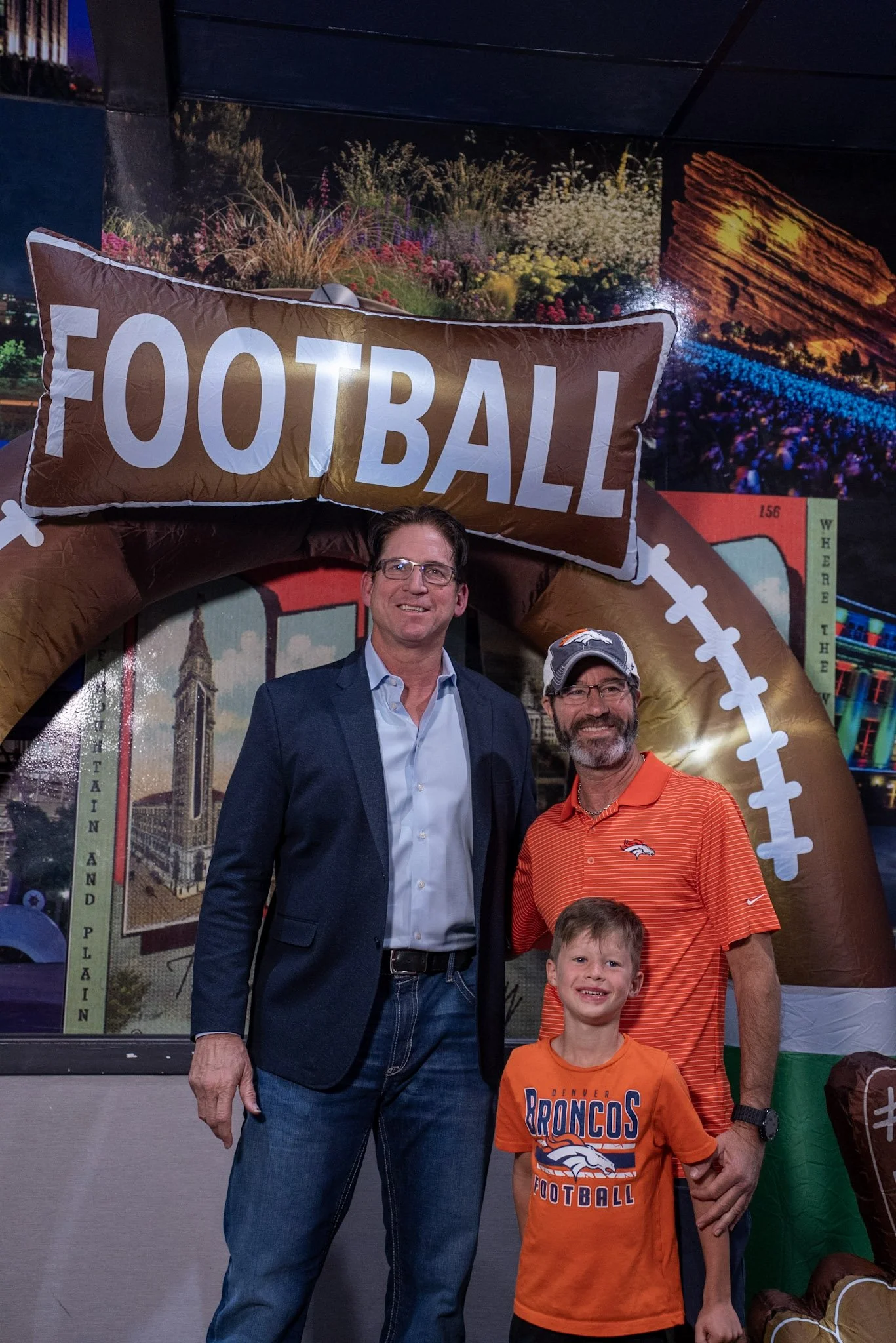 Ed McCaffrey smiles with two Denver Football Playbook fans during the post-show meet and greet.