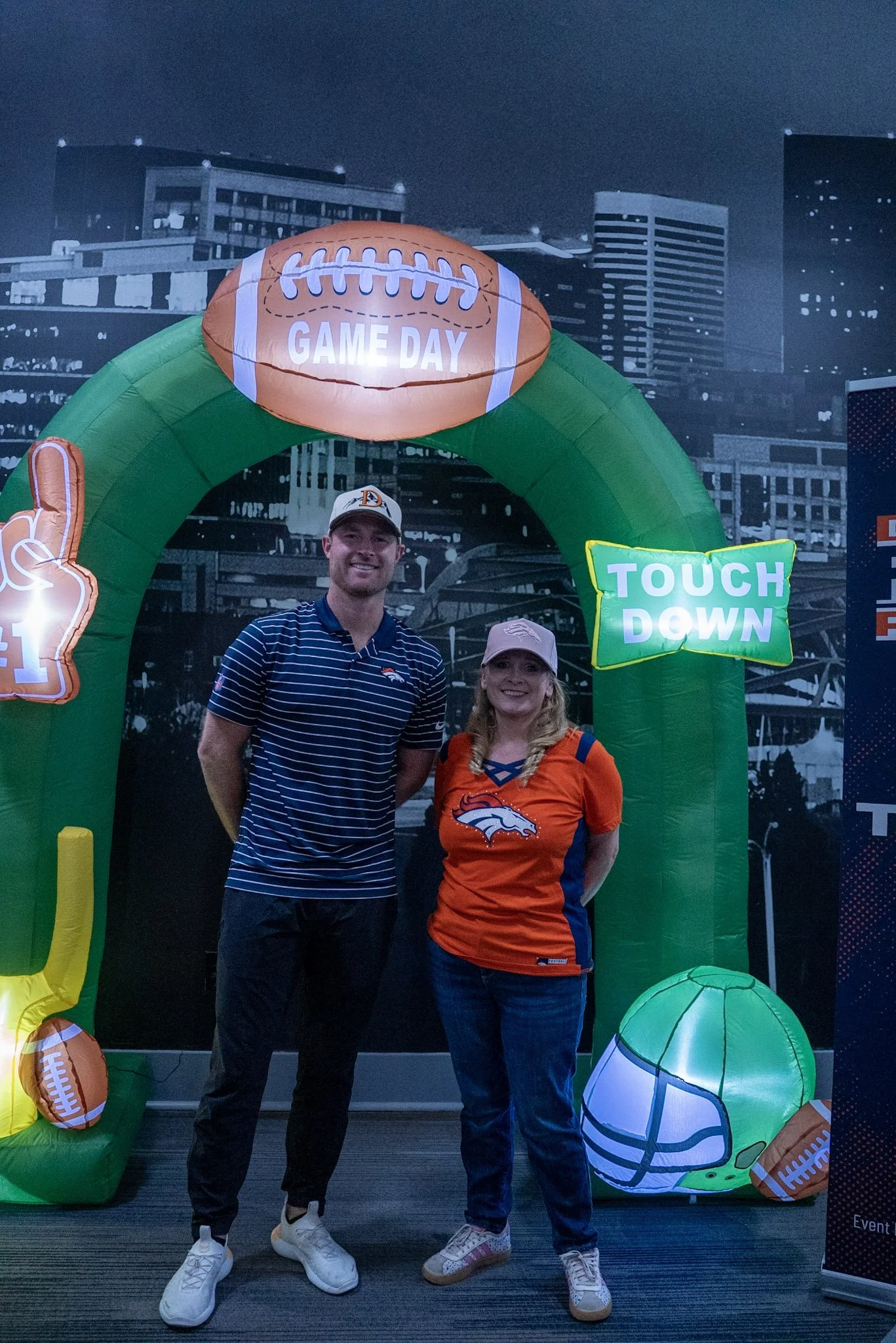 Wil Lutz takes a photo with a fan after the Denver Football Playbook live show at Dave & Busters in Westminster, Colorado