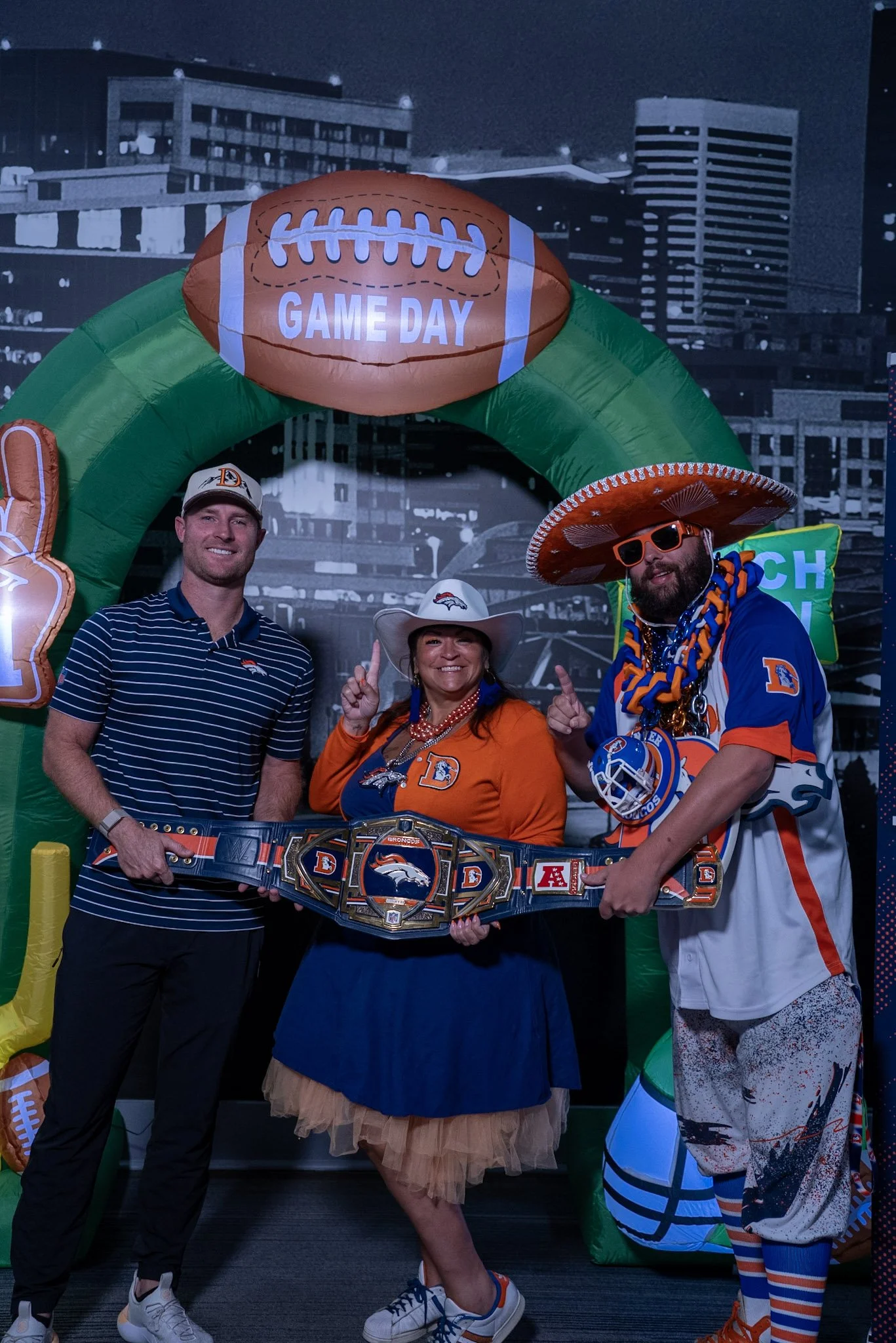Will Lutz takes a photo with two fans after the Denver Football Playbook live show