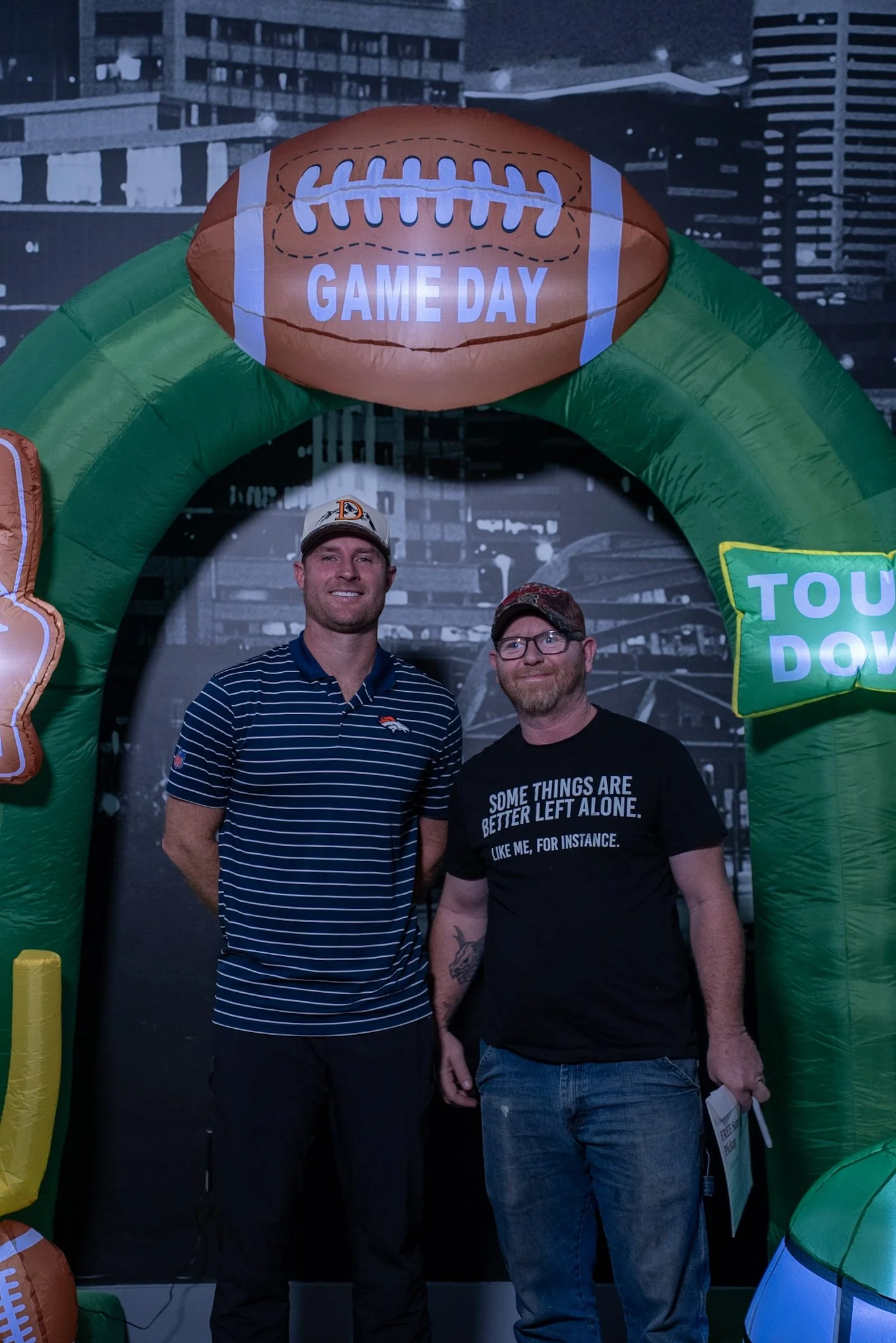 Wil Lutz takes a photo with a fan after the Denver Football Playbook live show