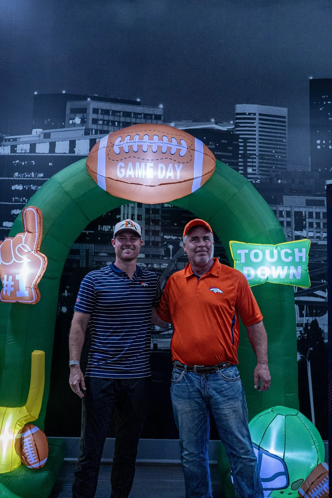 Wil Lutz takes a photo with a fan after the Denver Football Playbook live show at Dave & Busters 