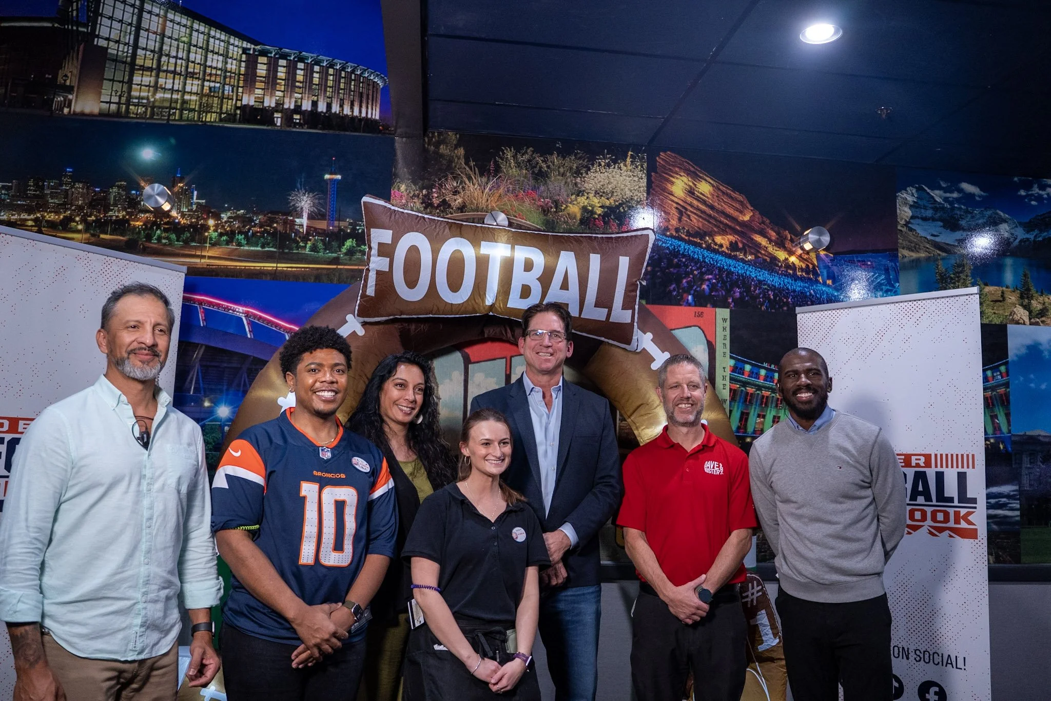 Ed McCaffrey poses with a group of guests at the Denver Football Playbook meet and greet.