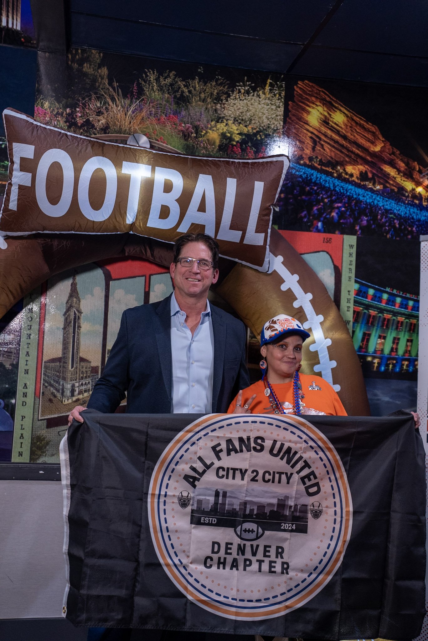Ed McCaffrey poses for a photo with a Denver Football Playbook guest after the live show.