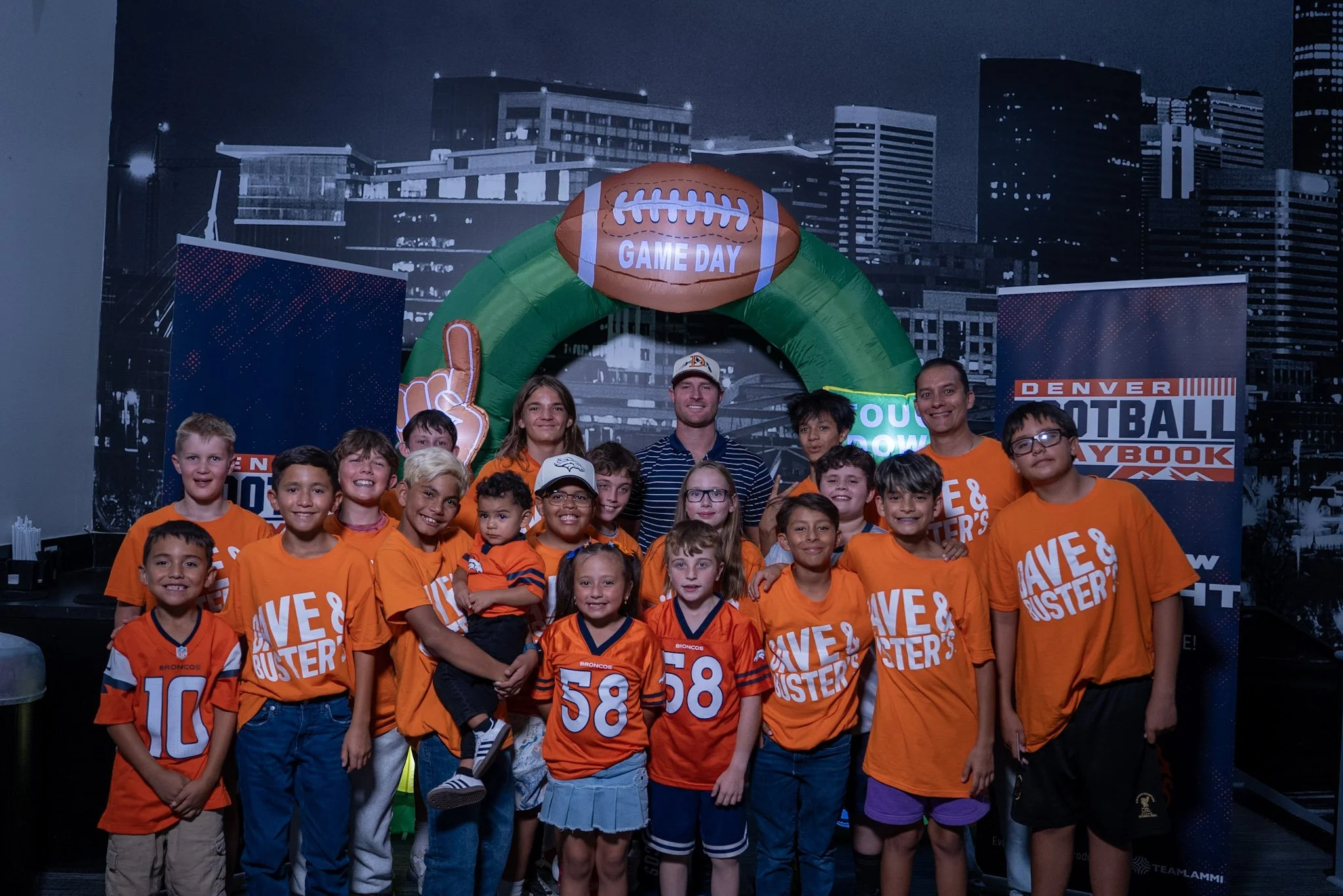 Wil Lutz poses with a group of kids at the Denver Football Playbook meet and greet