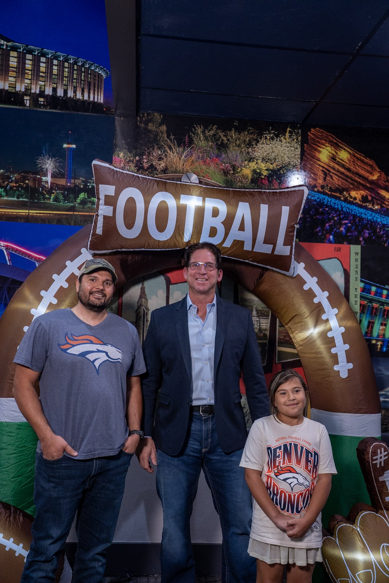 Ed McCaffrey smiles with two Denver Football Playbook guest during the post-show meet and greet.