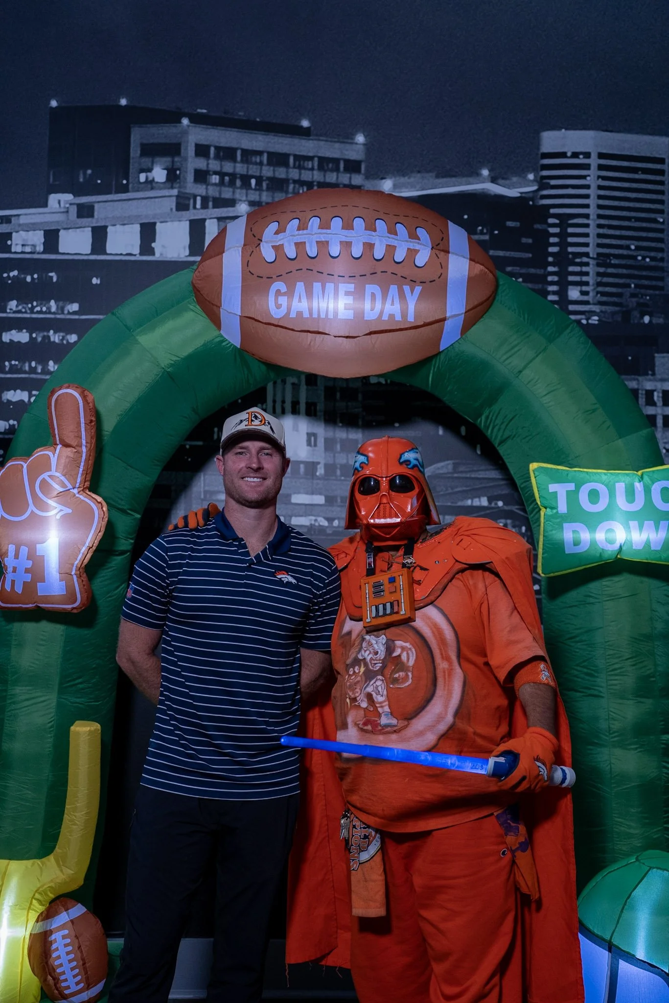 Wil Lutz takes a photo with a fan after the Denver Football Playbook live show