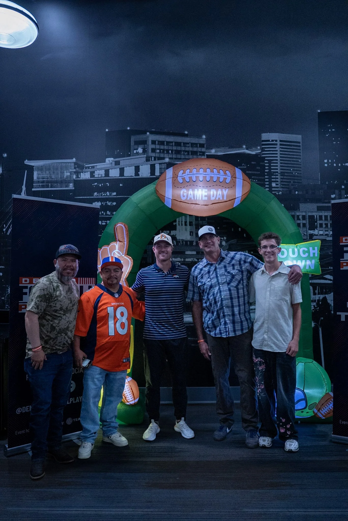 Wil Lutz poses for a photo with a group of fans at the Denver Football Playbook meet and greet